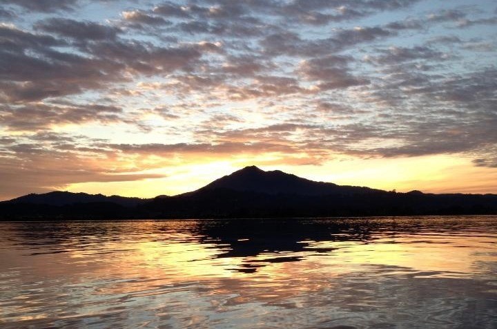 five children smiling while doing peace hand sign