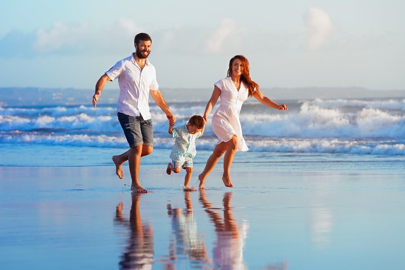 Australian family smiling together outdoors, representing modern middle-class life in Australia amid rising living costs