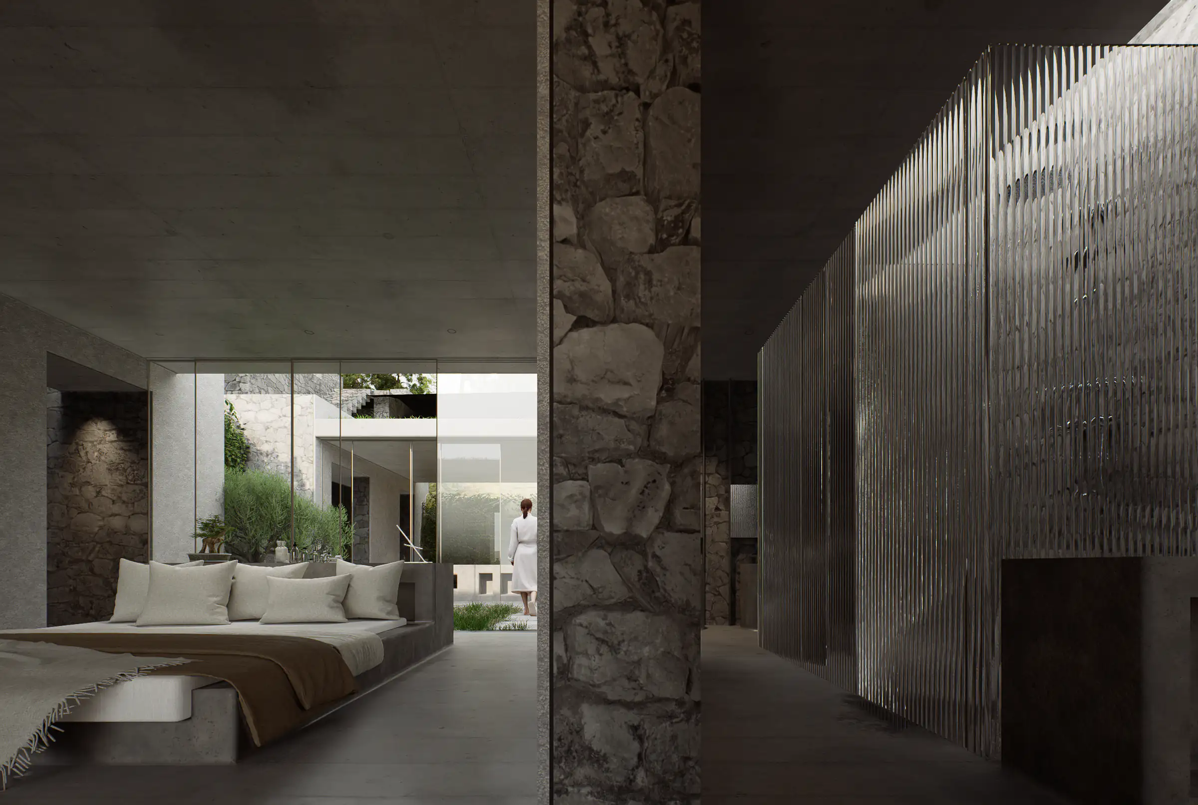 Interior with stone and concrete surfaces, a bed on the left and a textured glass partition on the right