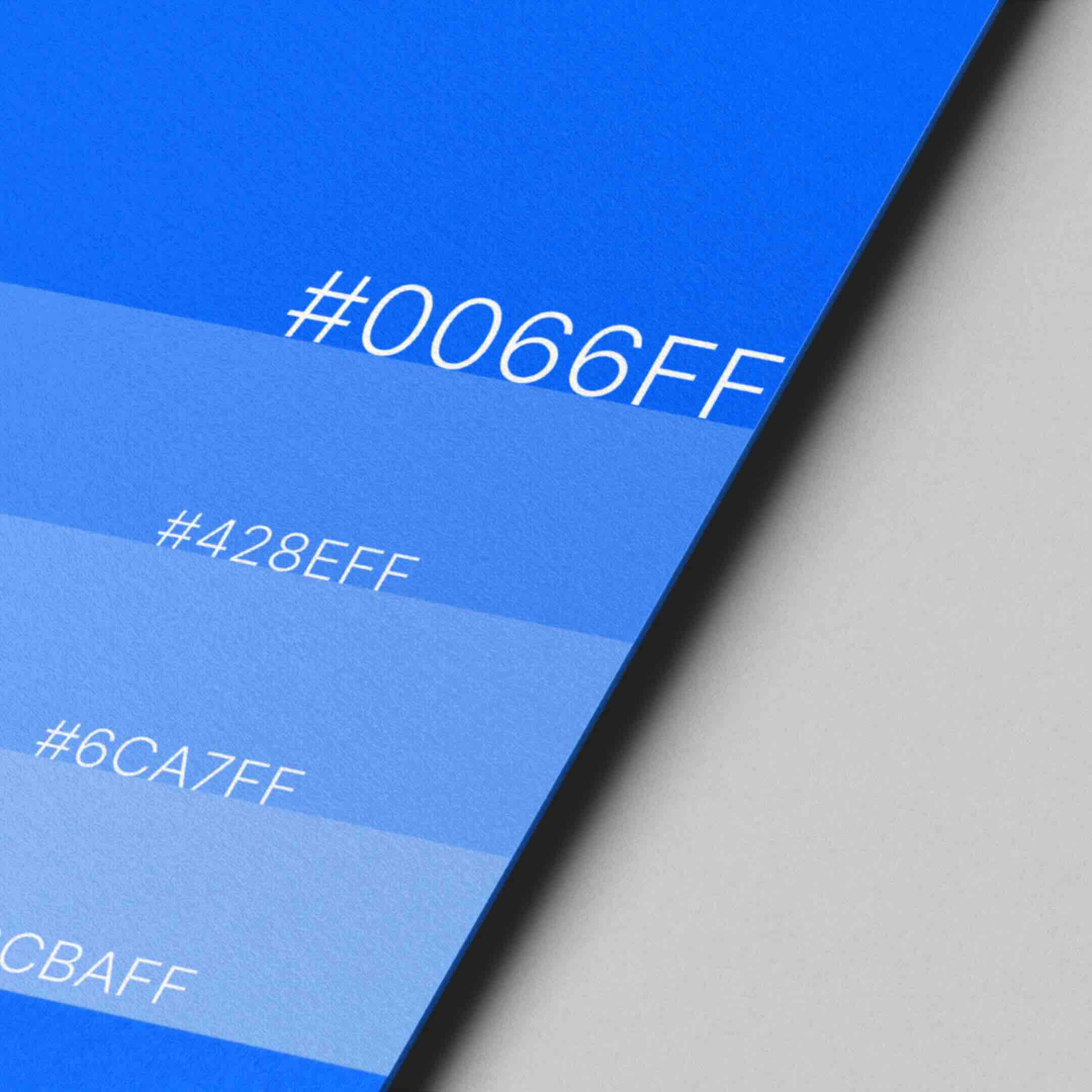 Elegant hand against a red background wearing two gold bracelets, one sleek and minimal, the other a delicate chain.