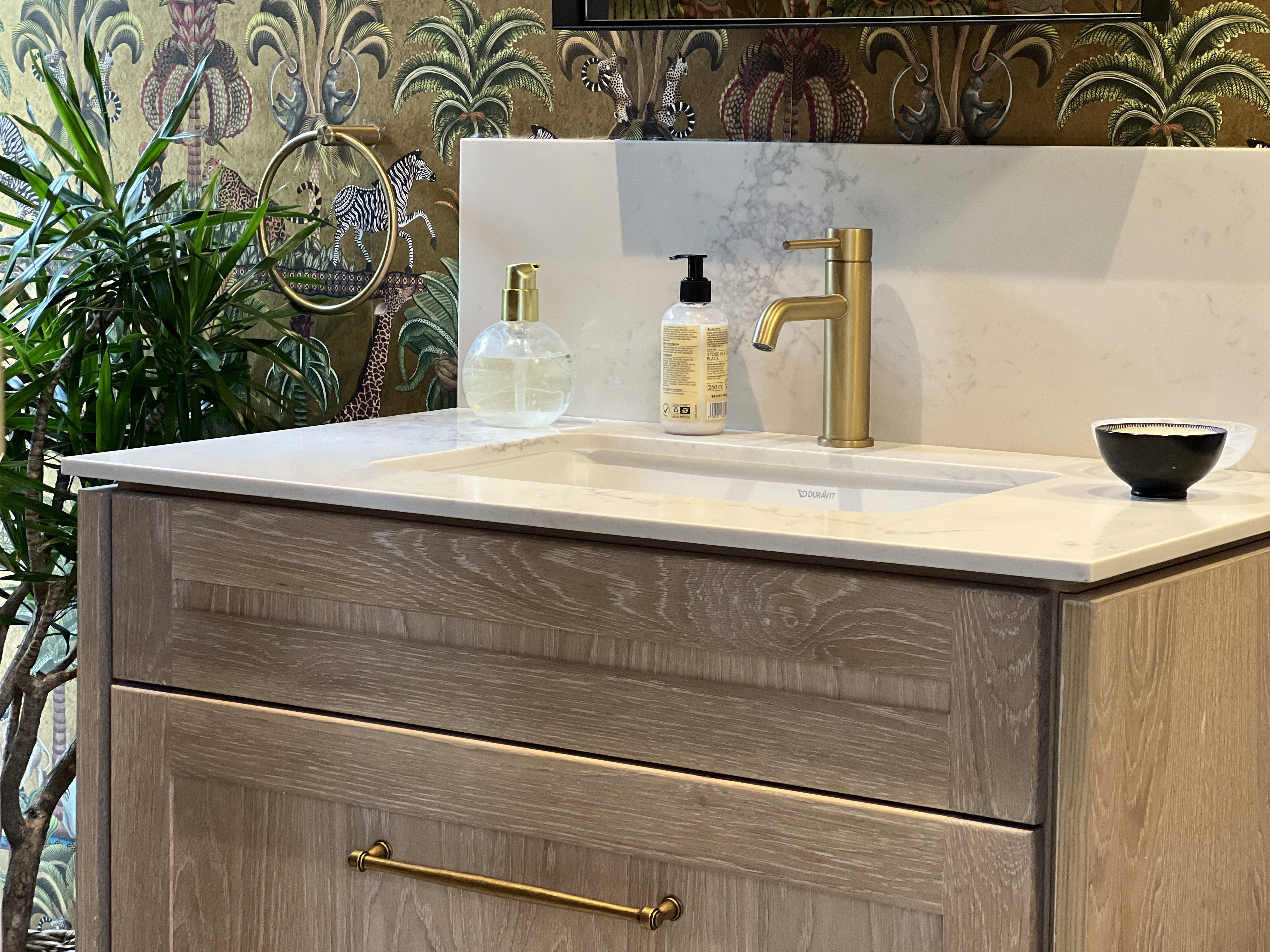 Modern interior entrance with floor-to-ceiling glass walls and warm timber cladding overlooking landscape