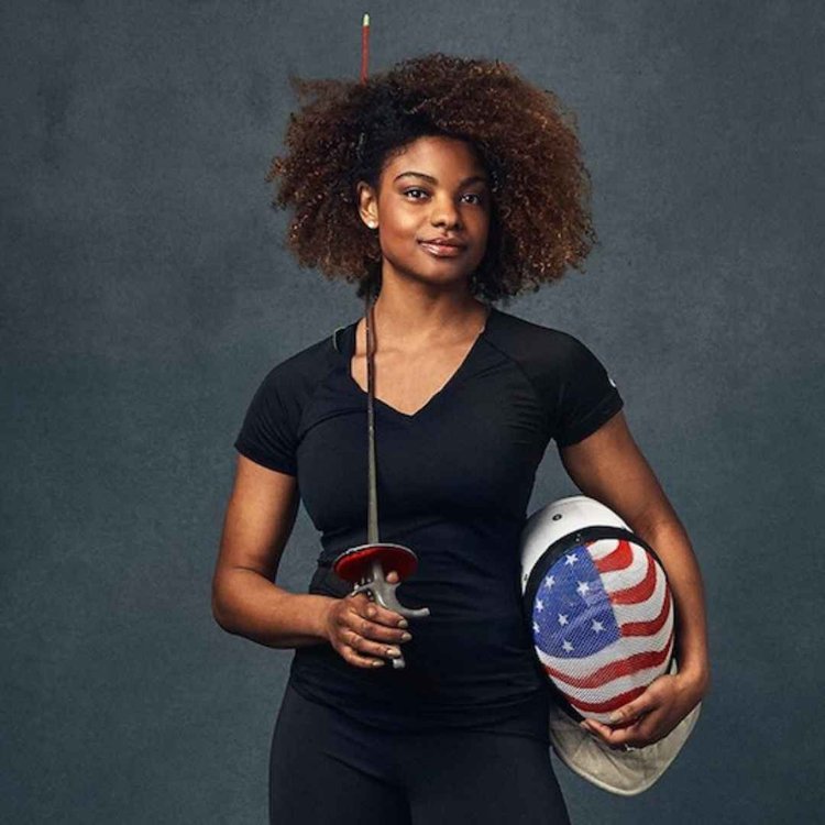 Nzingha Prescod stand with fencing equipment 