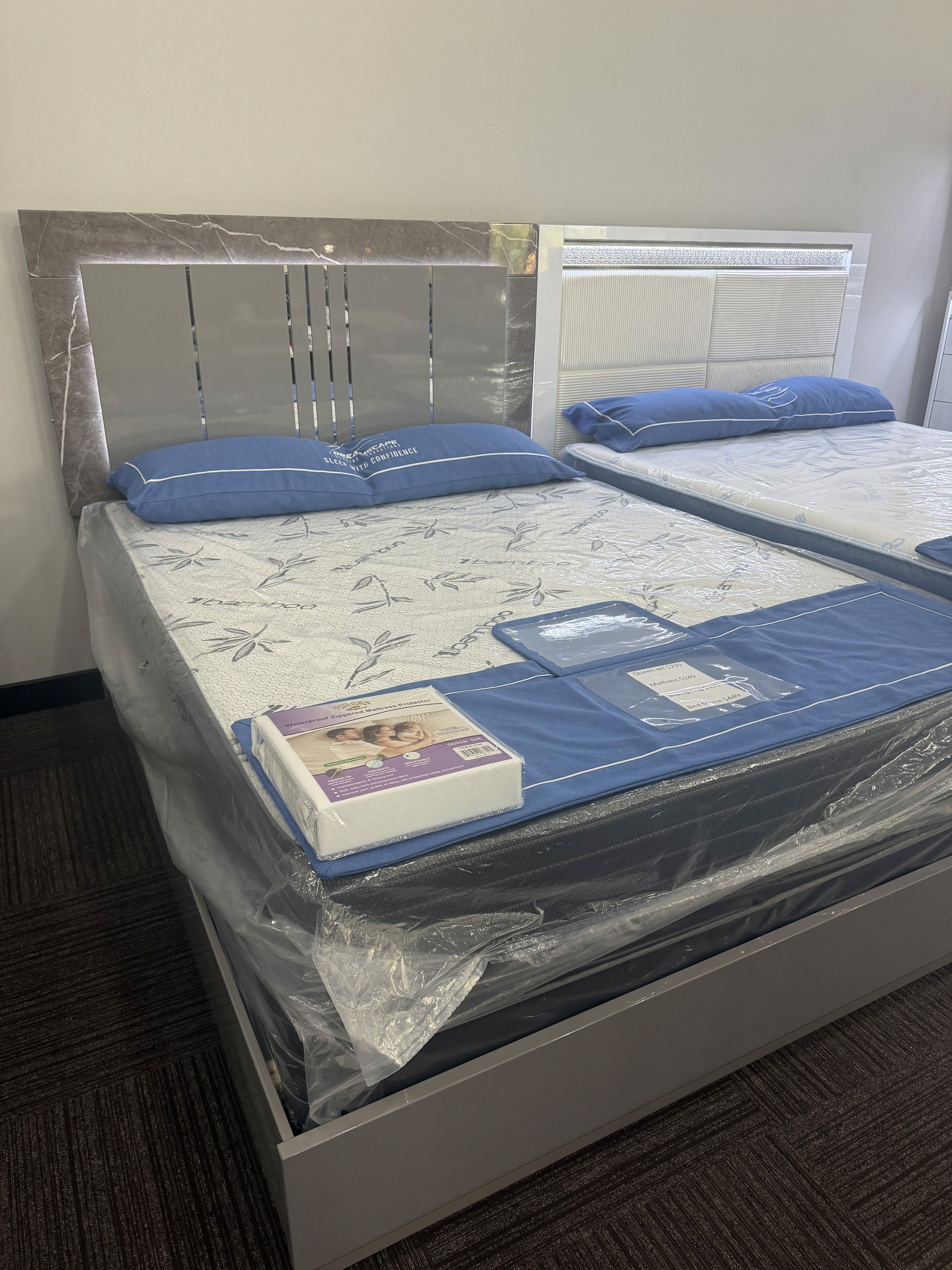 Dark wood bed frame and mattress in the showroom