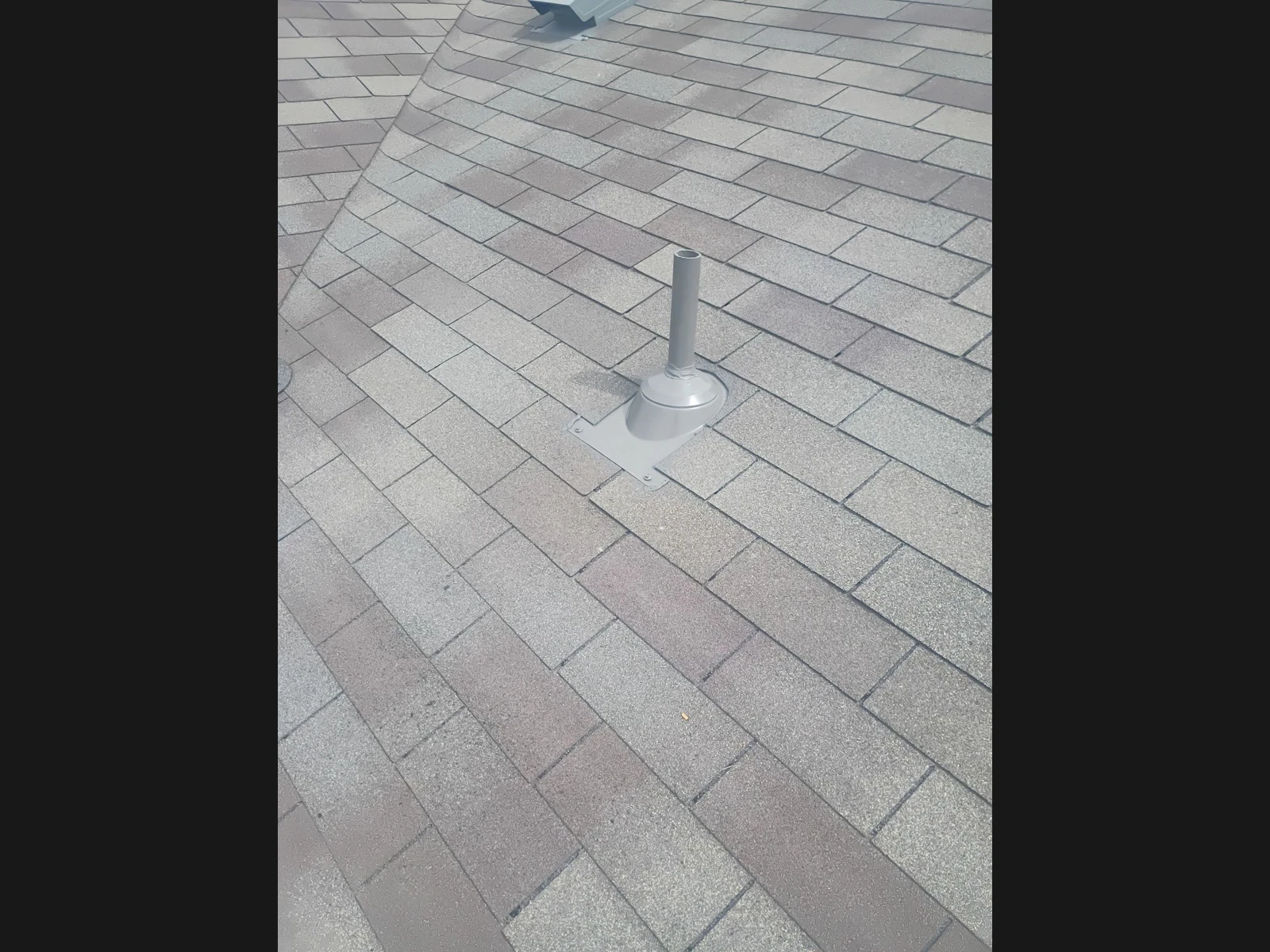 Repaired pipe boot and surrounding shingles in Converse, Texas.