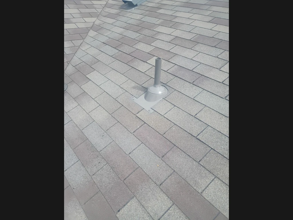 Repaired pipe boot and surrounding shingles in Converse, Texas.