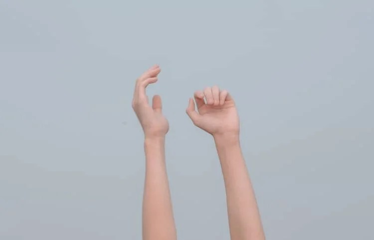 a photo of hands thrown up in the air