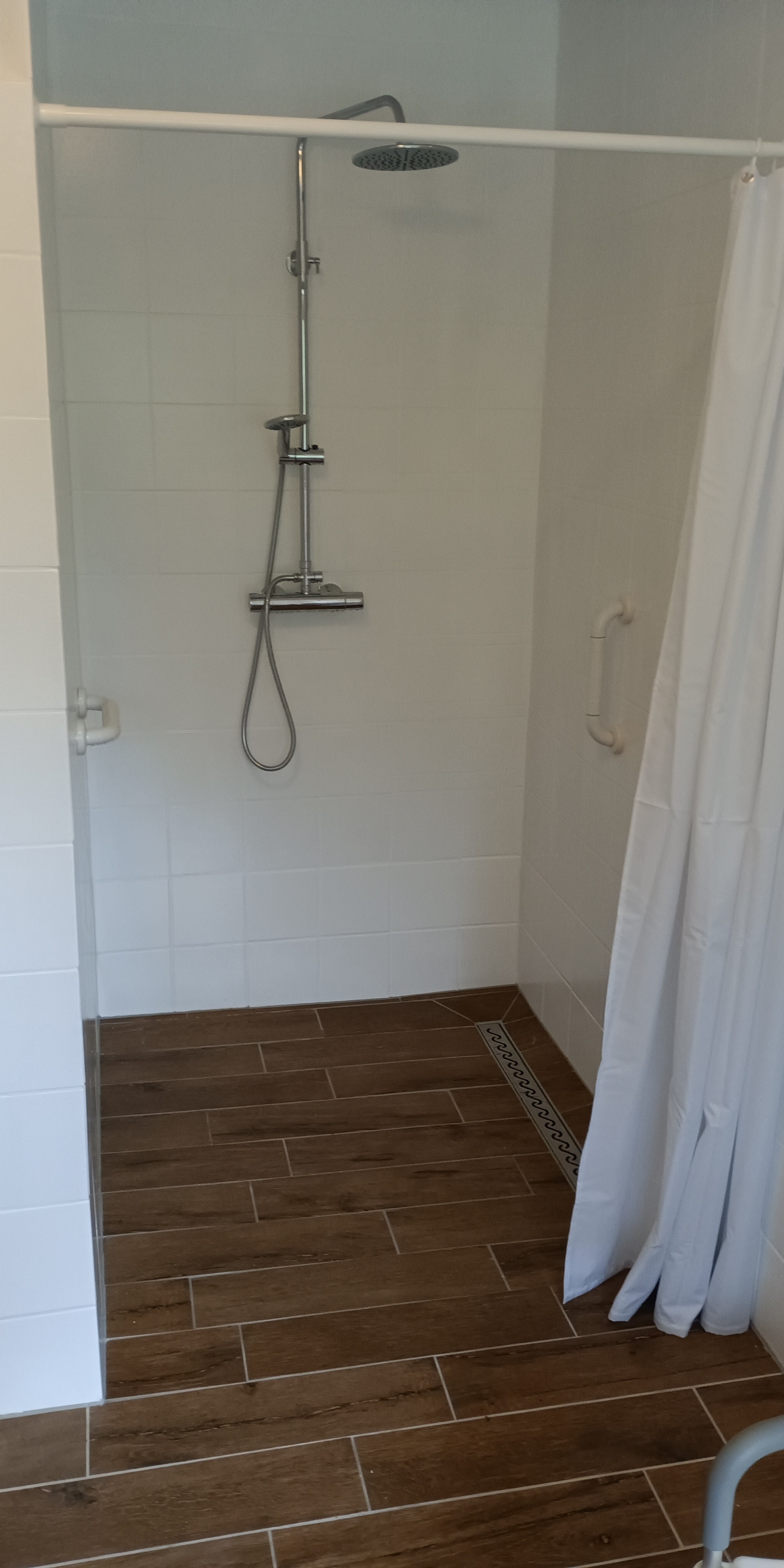 white ceramic bathtub near white framed window