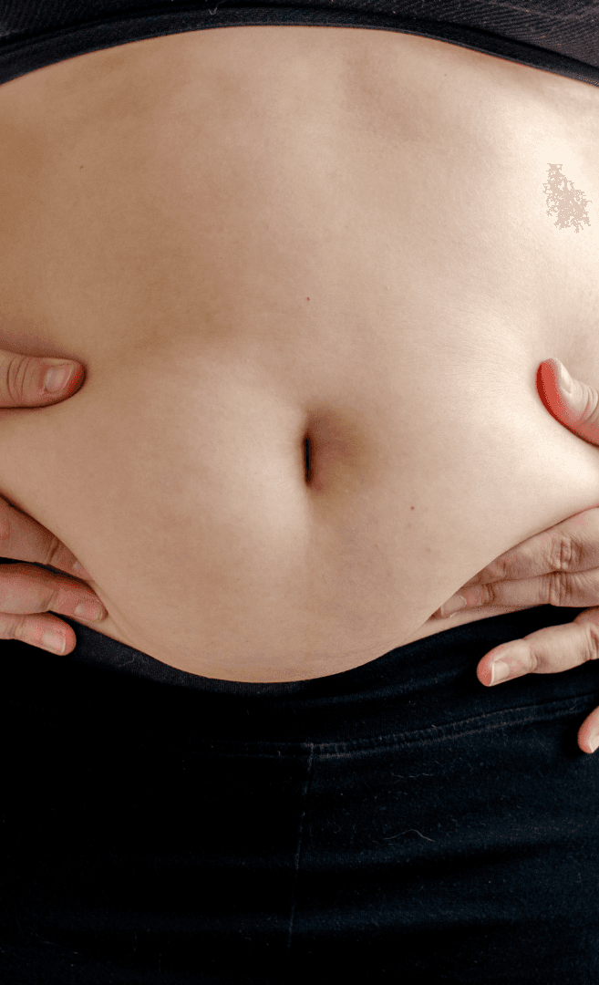 A smiling young man with crossed arms, wearing a plaid shirt and white t-shirt, poses against a dark background.