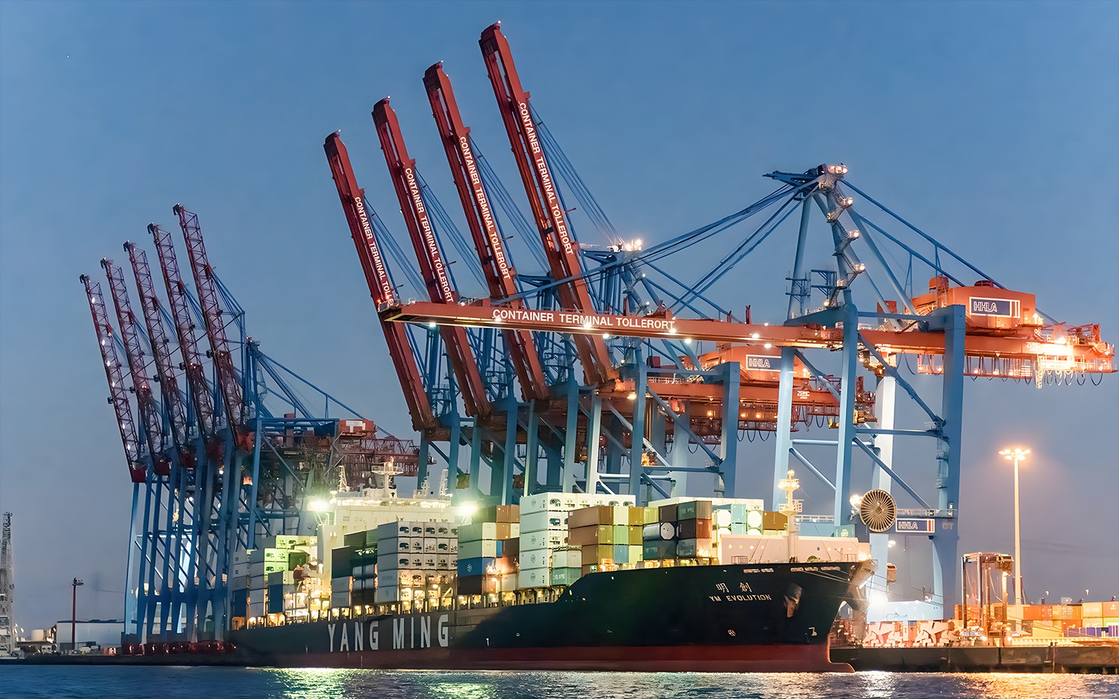 Large ship docked at Container Terminal Tollerort during evening lights cruise.