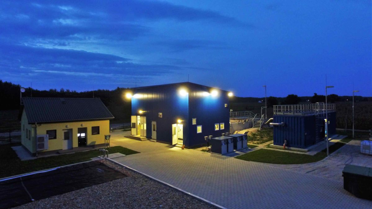 The Kunfehértó MEMBRATOR wastewater treatment plant lit at dusk, Hungary