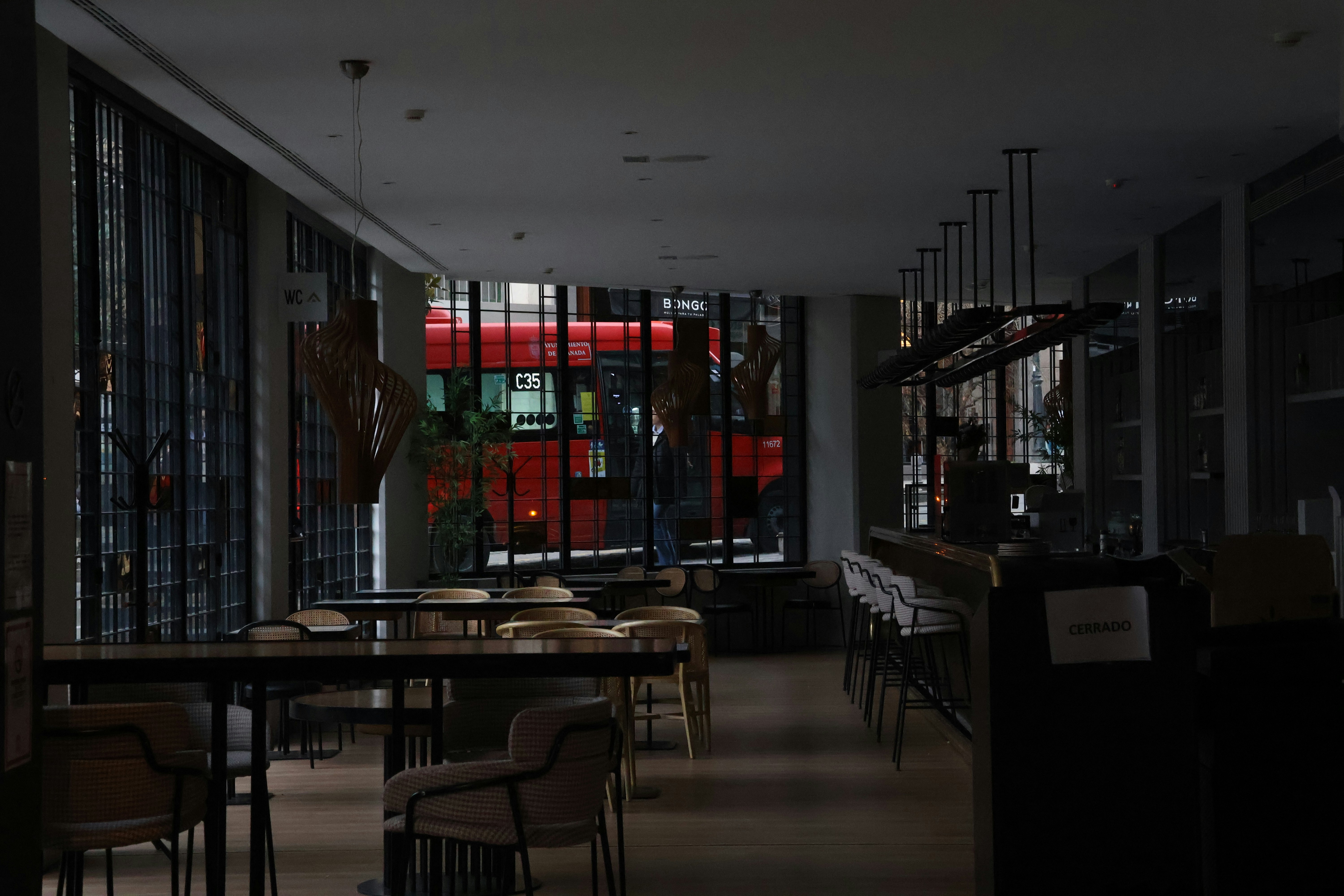 A blurry photo of a restaurant with tables and chairs