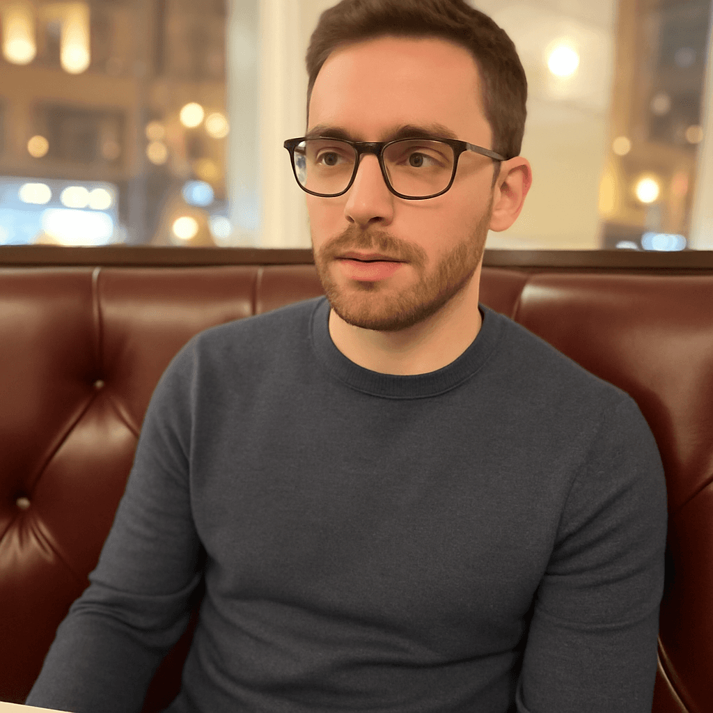 a man with a goatee smiles at the camera