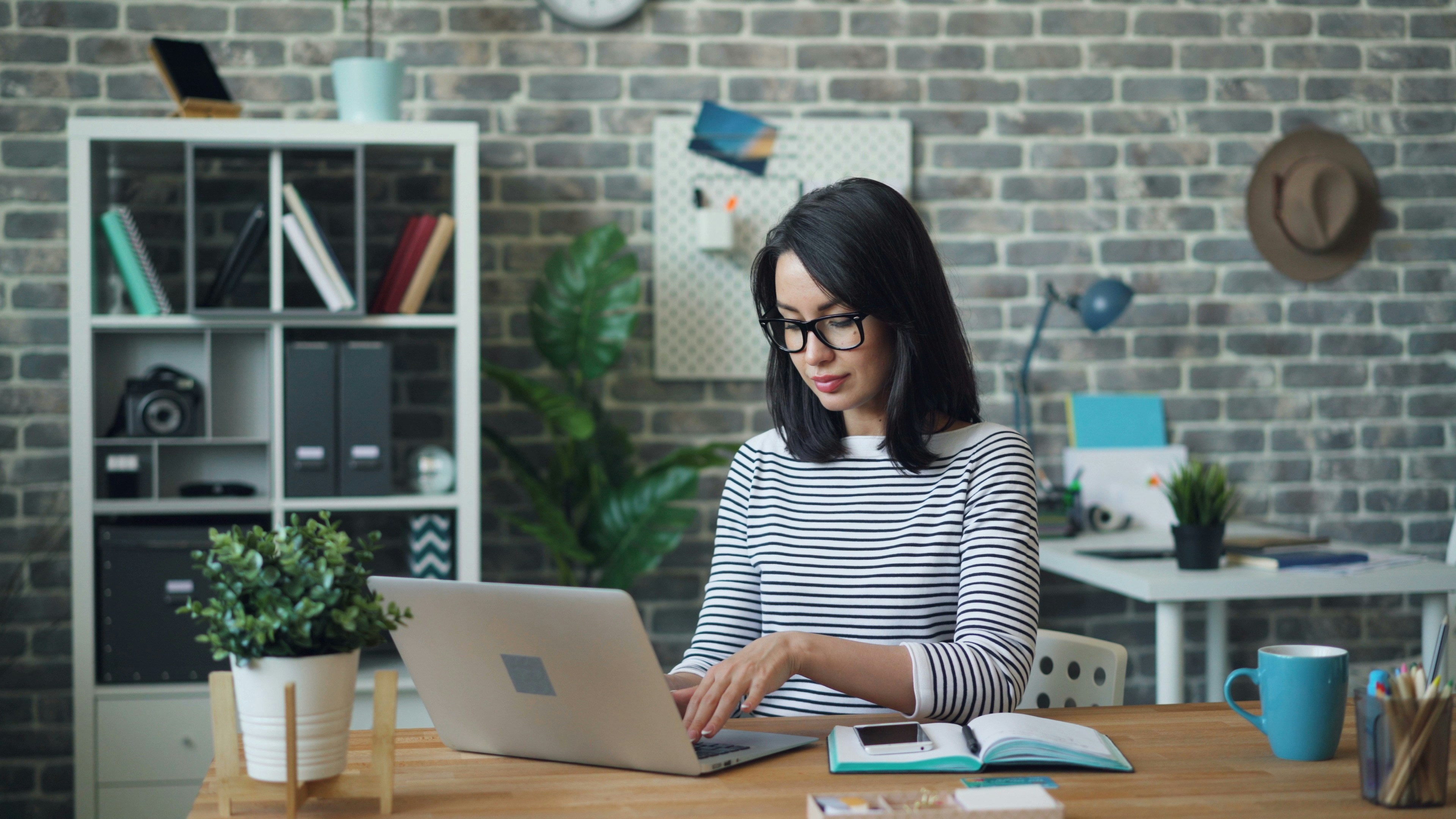 woman at her desk - AI Automation Tools