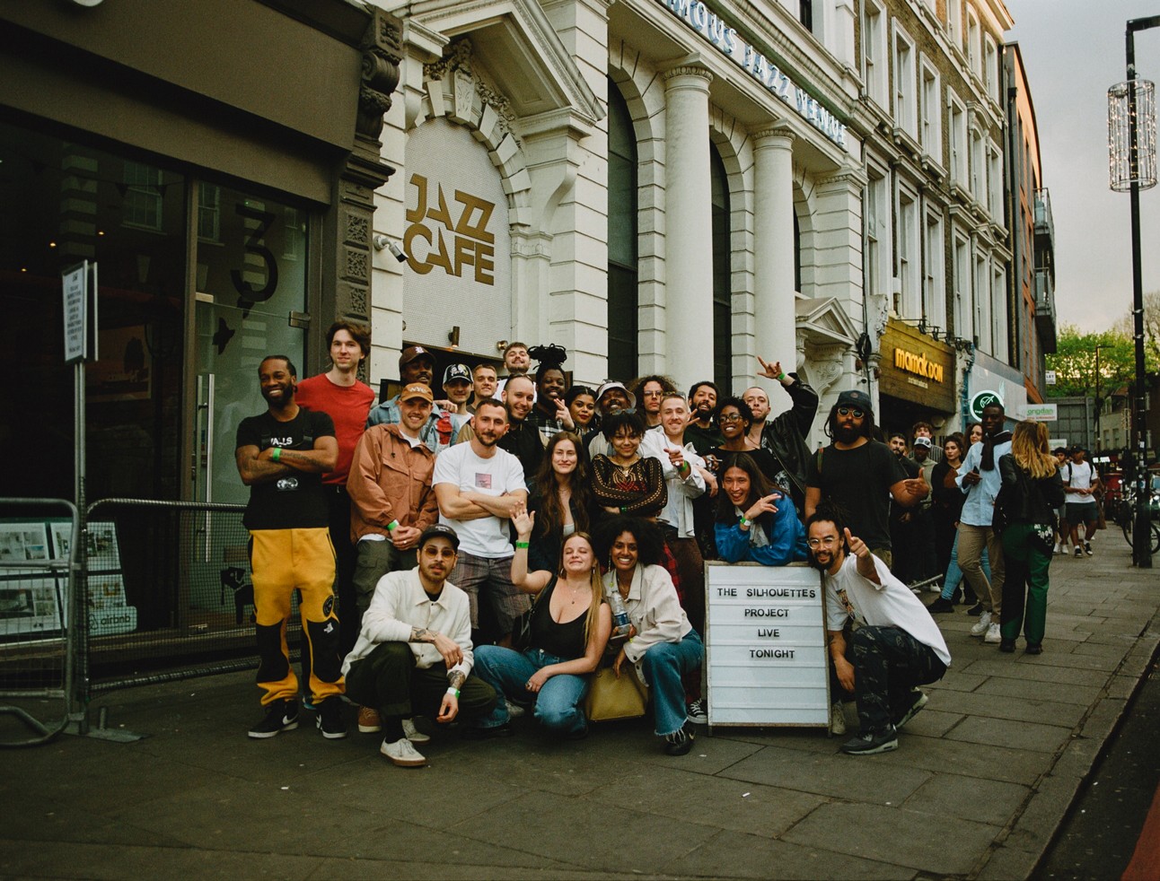 Root 73 artists and community members gathered outside a local venue.