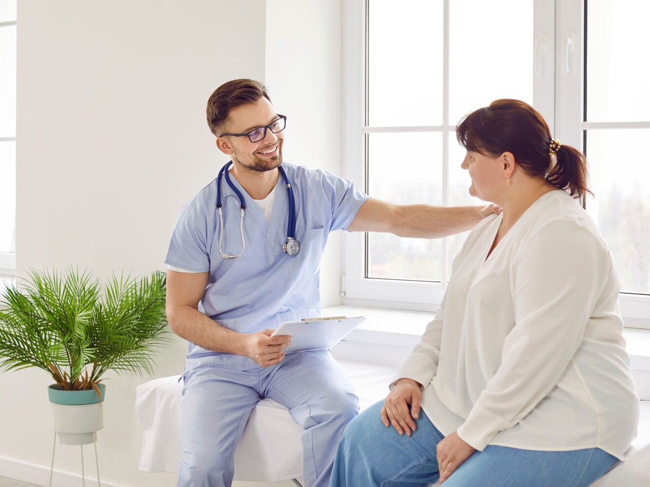 overweight woman meeting with her doctor to discuss a weight loss pills prescription