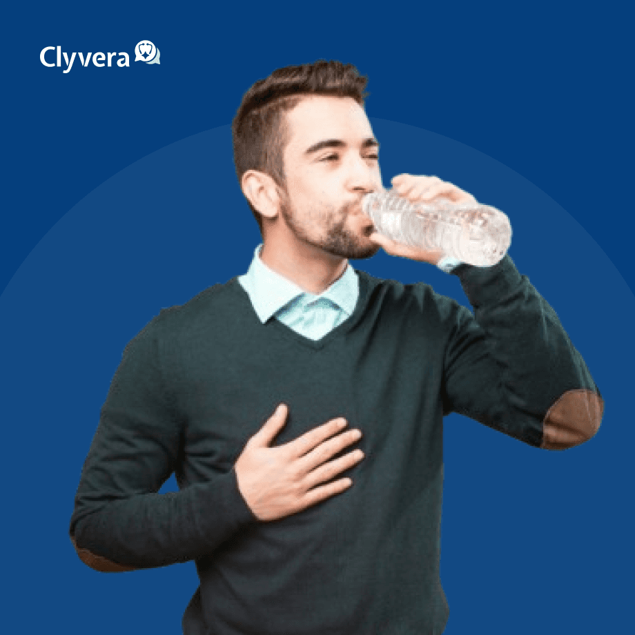a man drinking water from a bottle