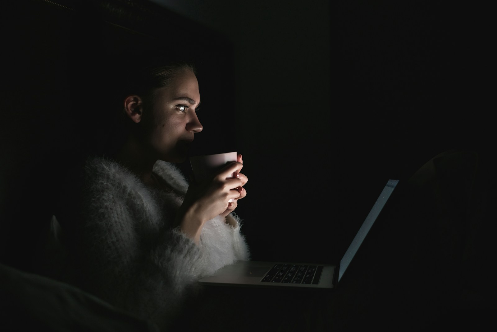 A person sitting in front of a laptop