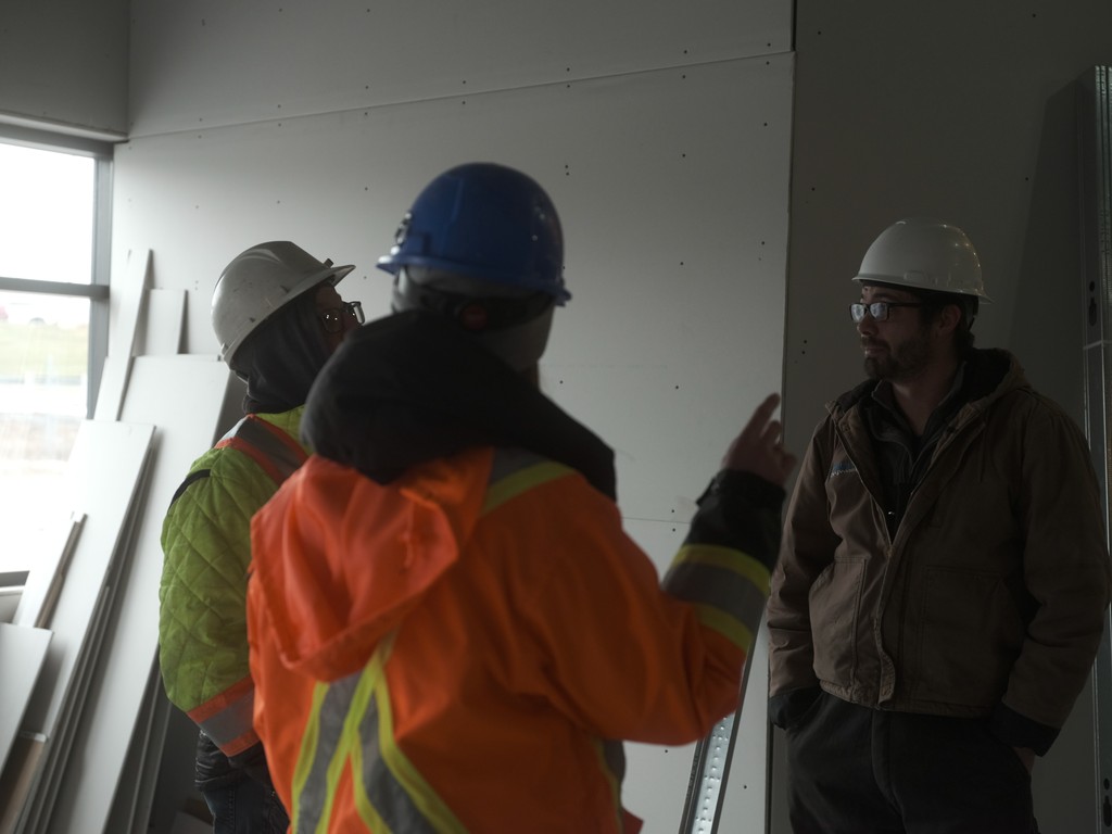 Worksite with customers and contractors discussing details of plan