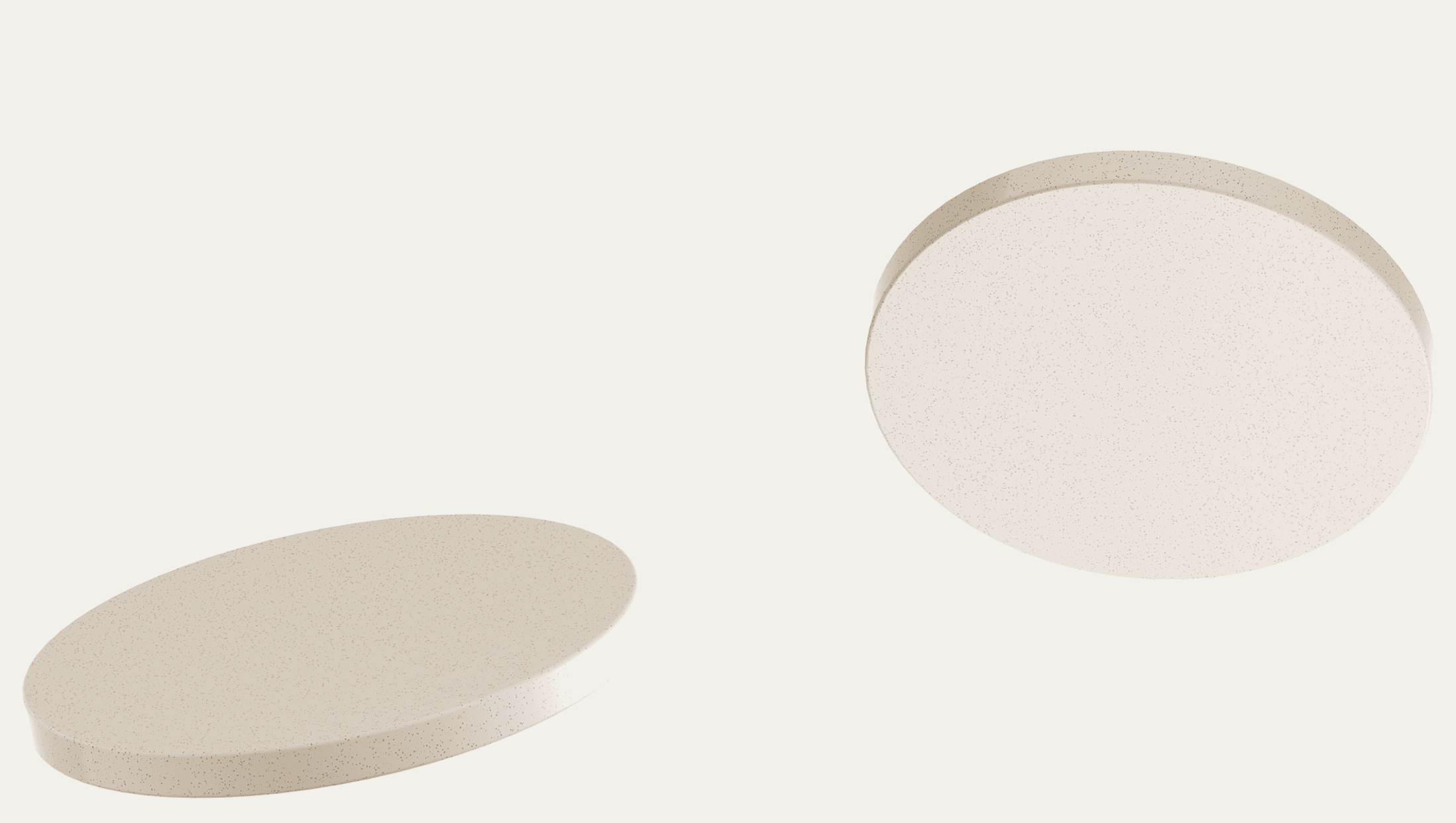 Two round, white tablets on a plain background. One lies flat, while the other is tilted. The image conveys simplicity and minimalism.