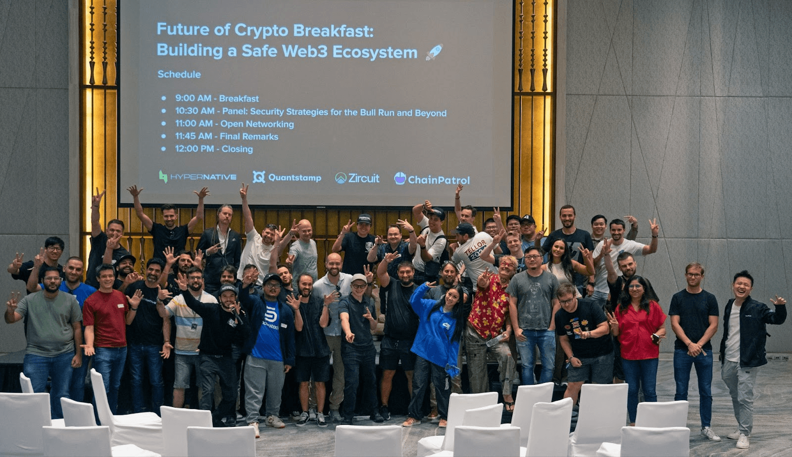 a group of people standing in front of a screen that reads Future of Crypto Breakfast