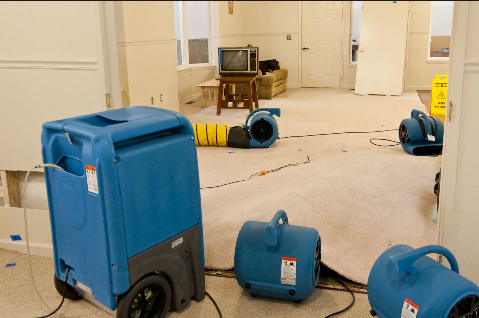 a man in a yellow vest is cleaning the street
