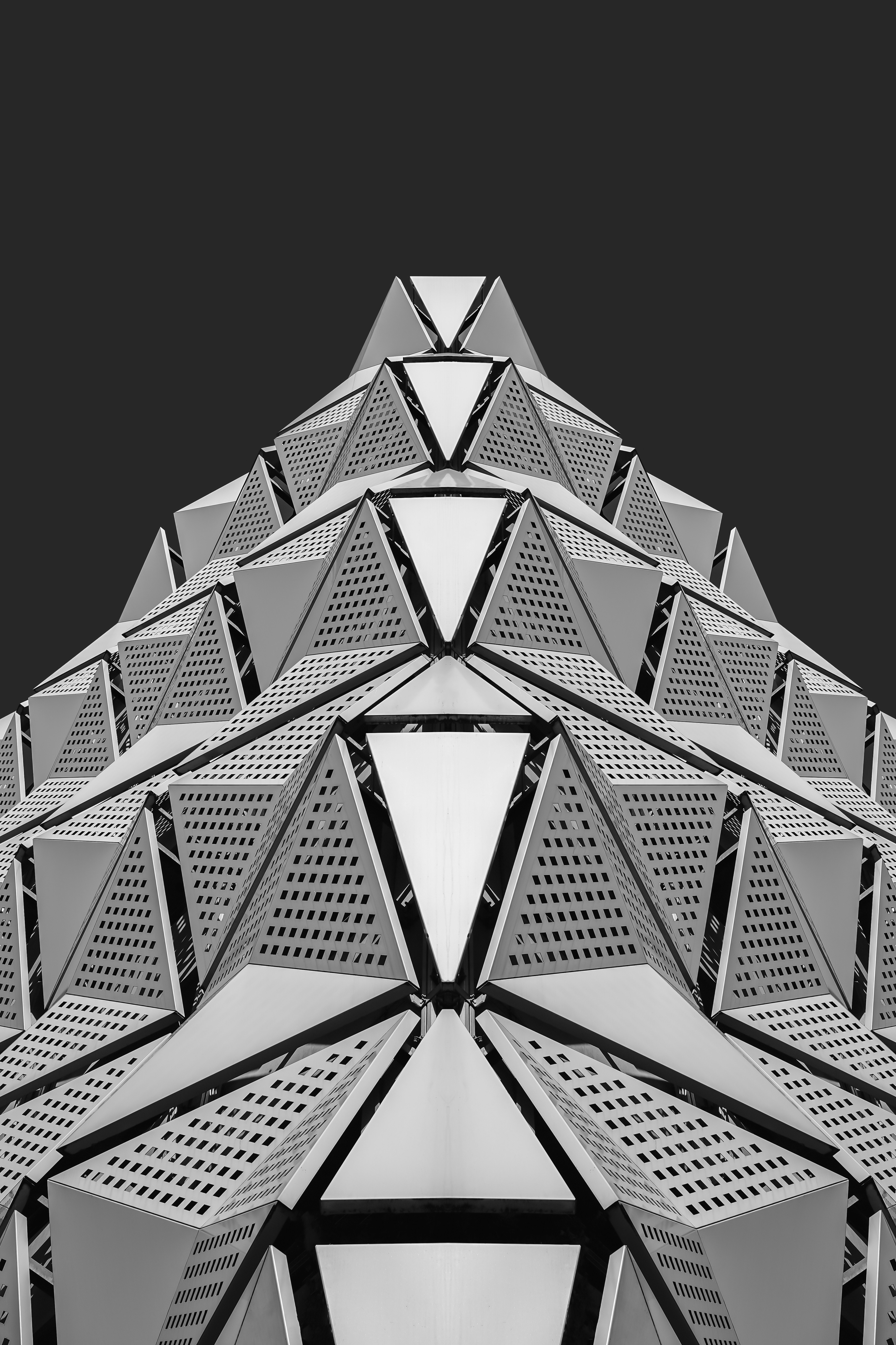 Geometric architectural structure with repeating triangular patterns.