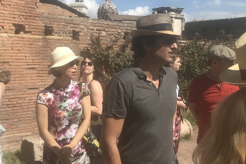 A photo of a group of people visiting some ancient ruins in Rome.