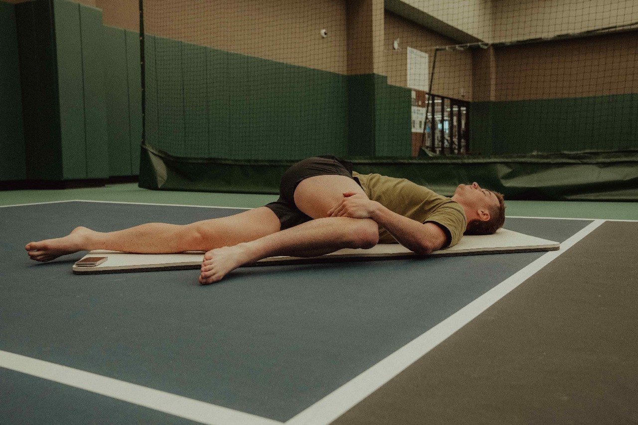 Person Stretching - How to Speed Up Muscle Strain Recovery