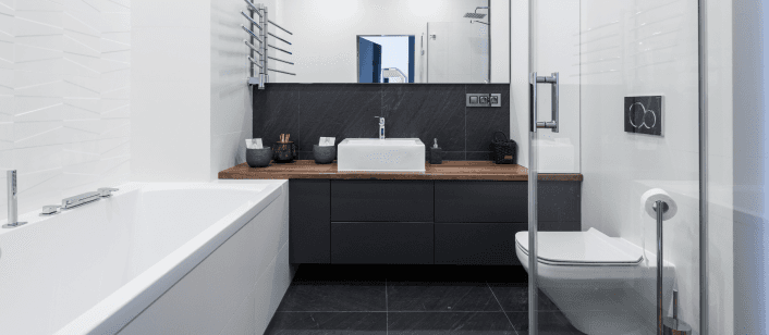 Modern bathroom with bathtub, sink, and toilet.