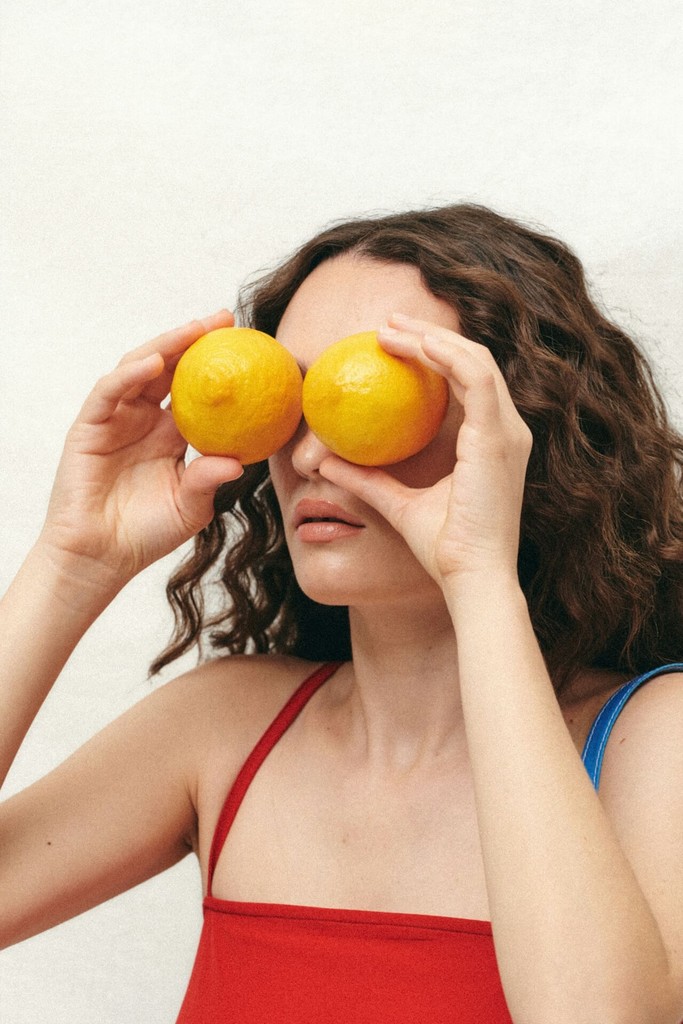 Close up of a woman's face putting moisturiser on her face