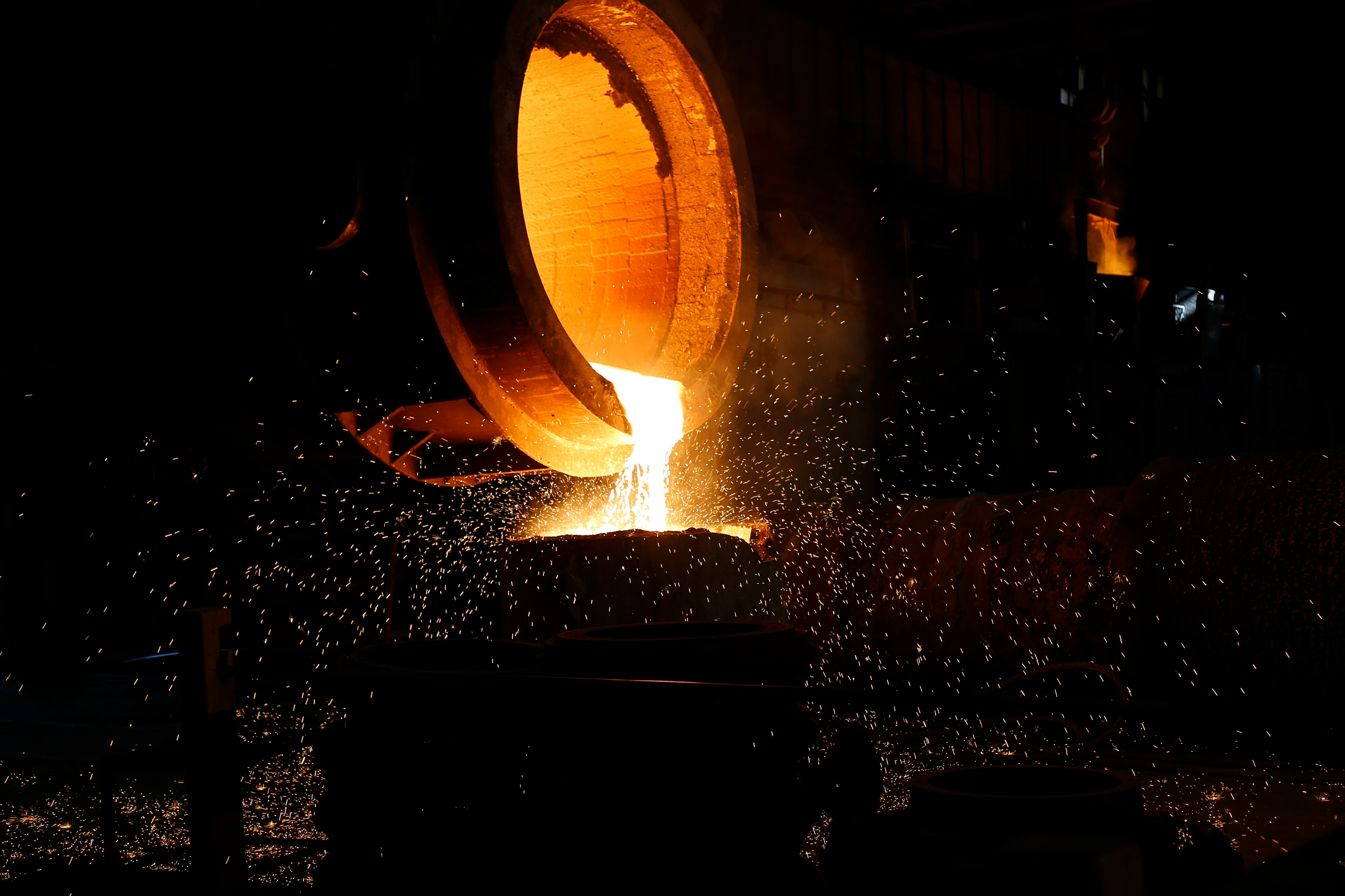 a large piece of metal being poured into a container
