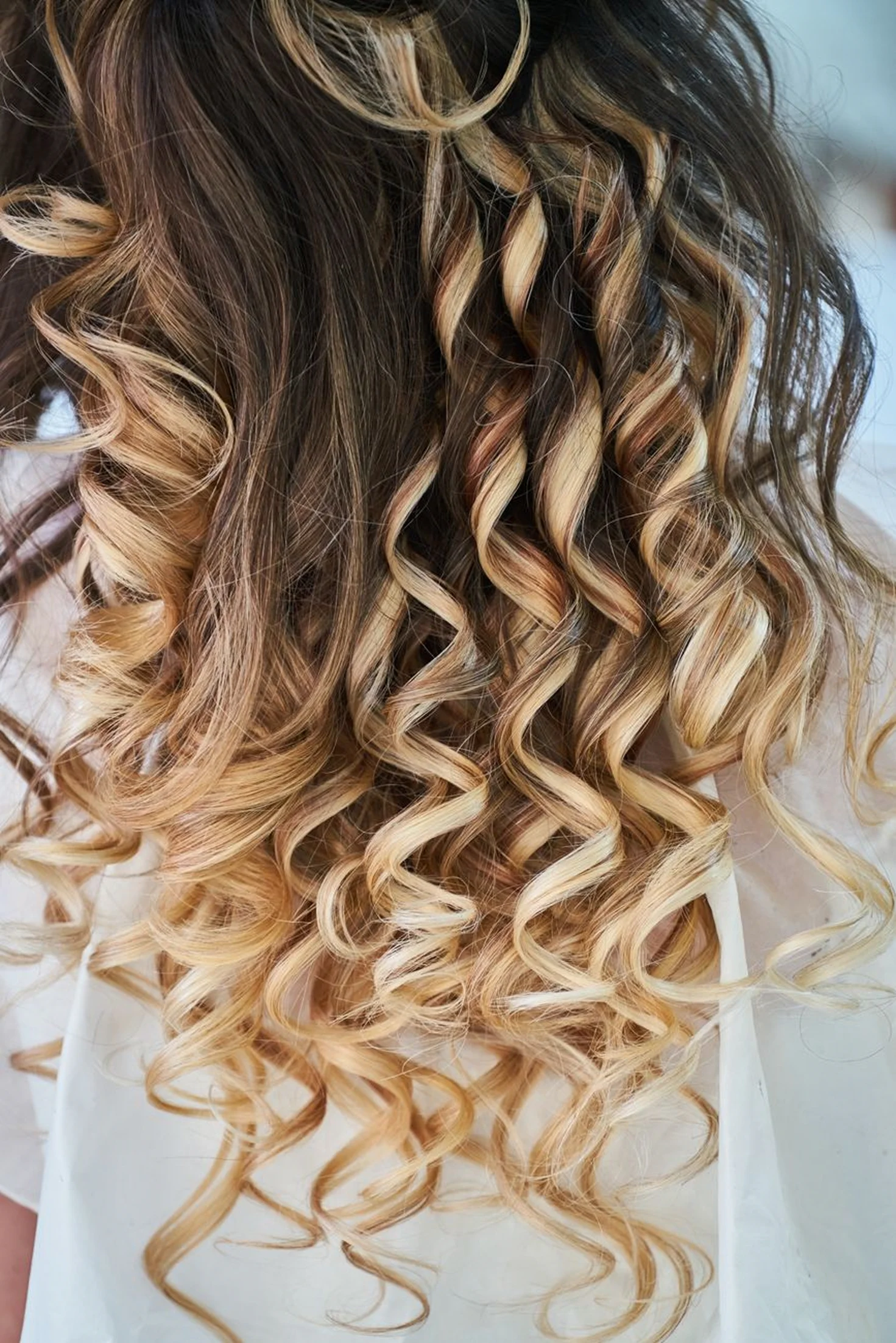Woman with soft textured waves from a perm service
