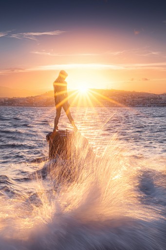 A black sand beach with mountains in the distance