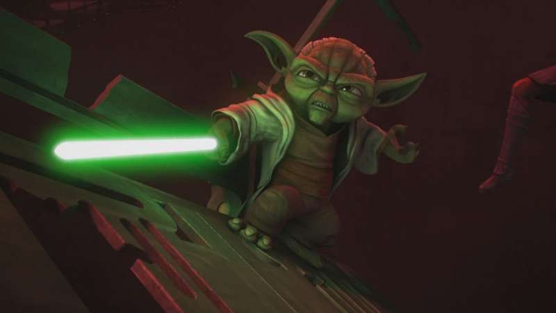 Yoda holding his green lightsaber