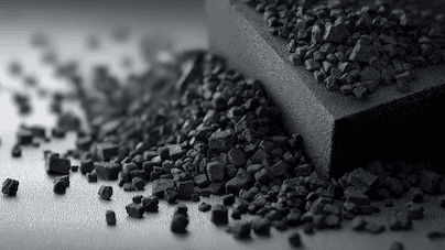 Two men discuss a project while standing at a laptop in an office.