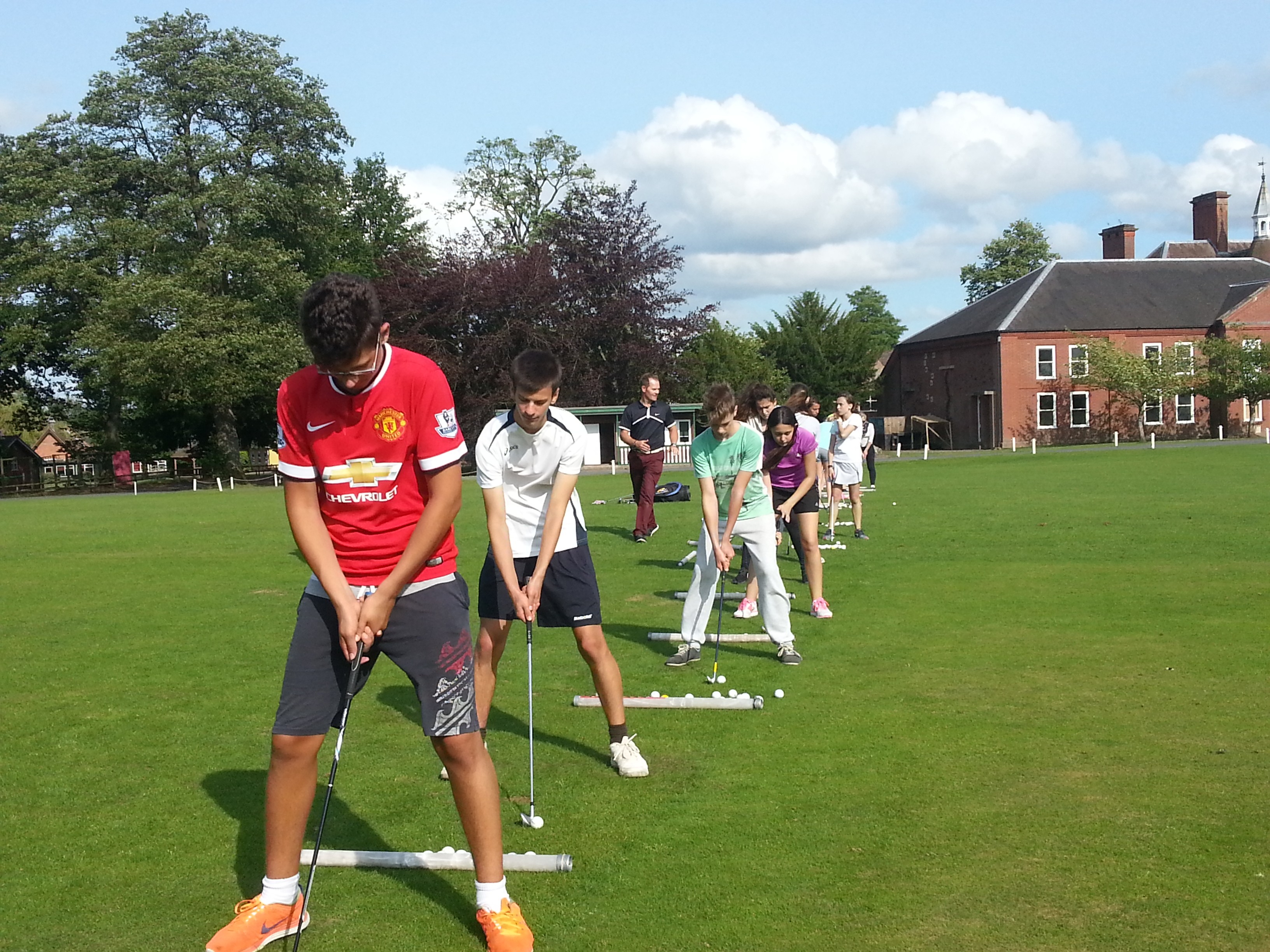 standing man wearing blue denim shorts