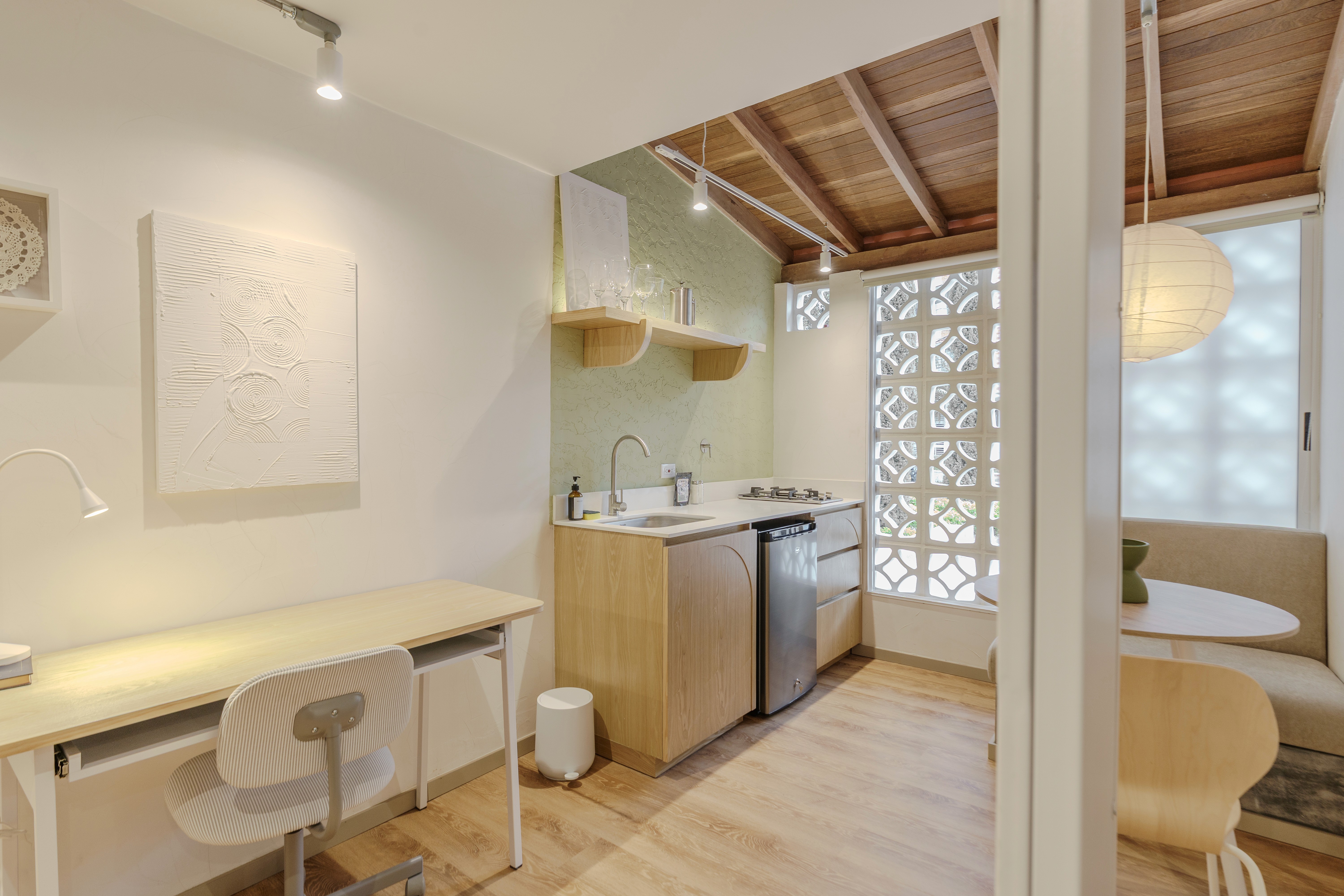 Double-height interior with flowing sculptural forms and warm raking light