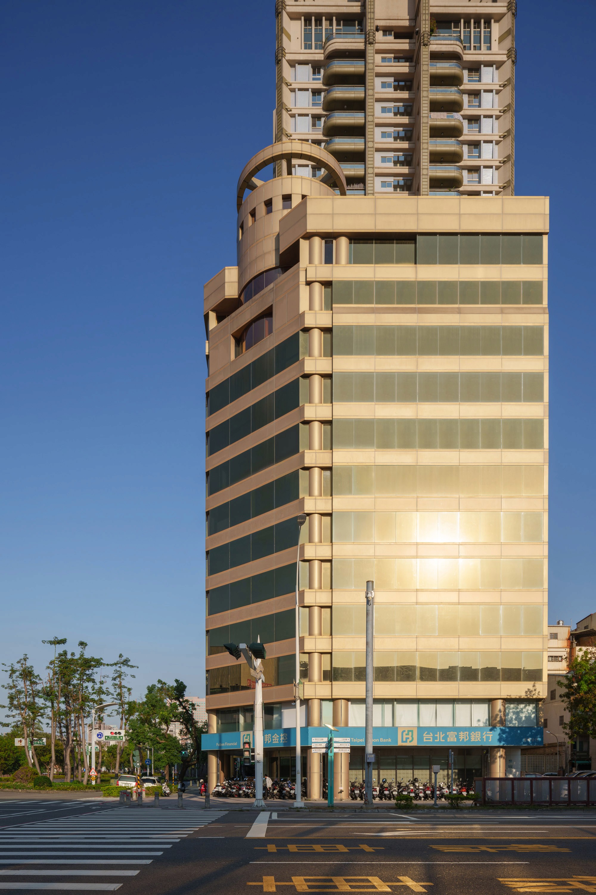 Daytime exterior of a multi-story hotel with glass facade
