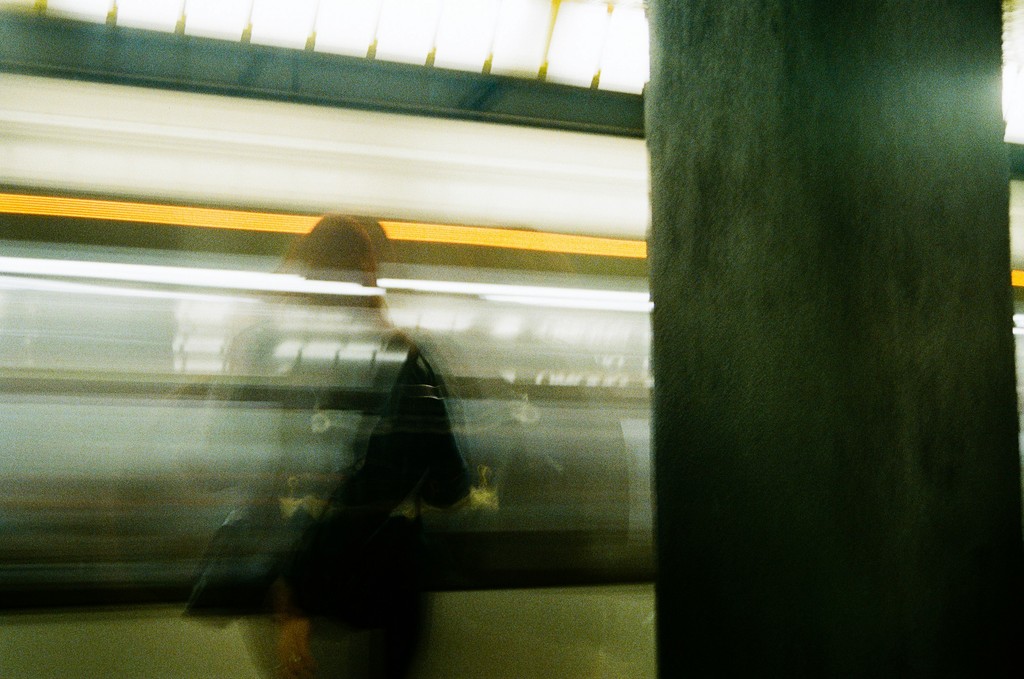 a blurry photo of a person walking on a subway platform
