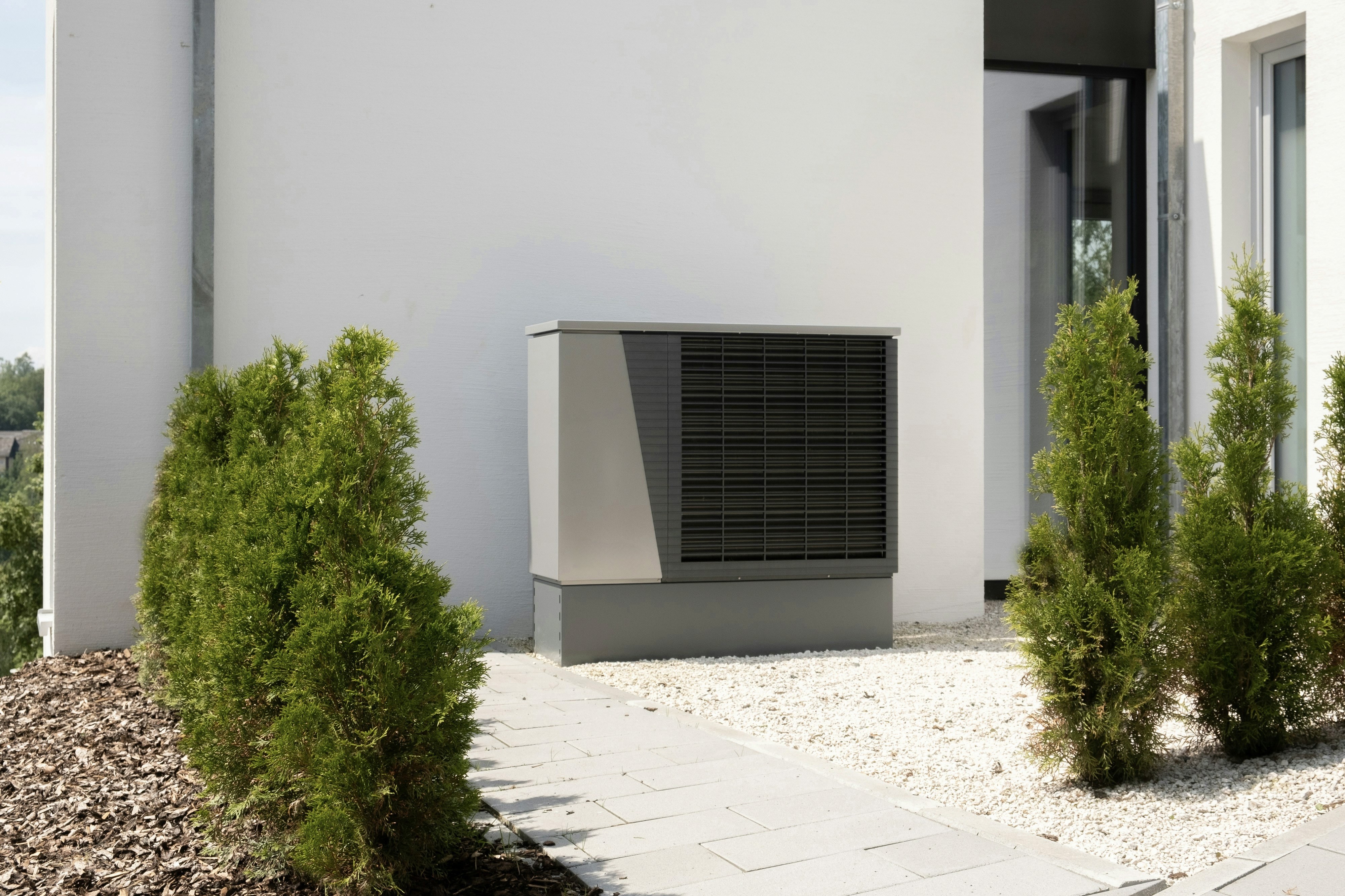 Modern home heat pump unit outside a California house