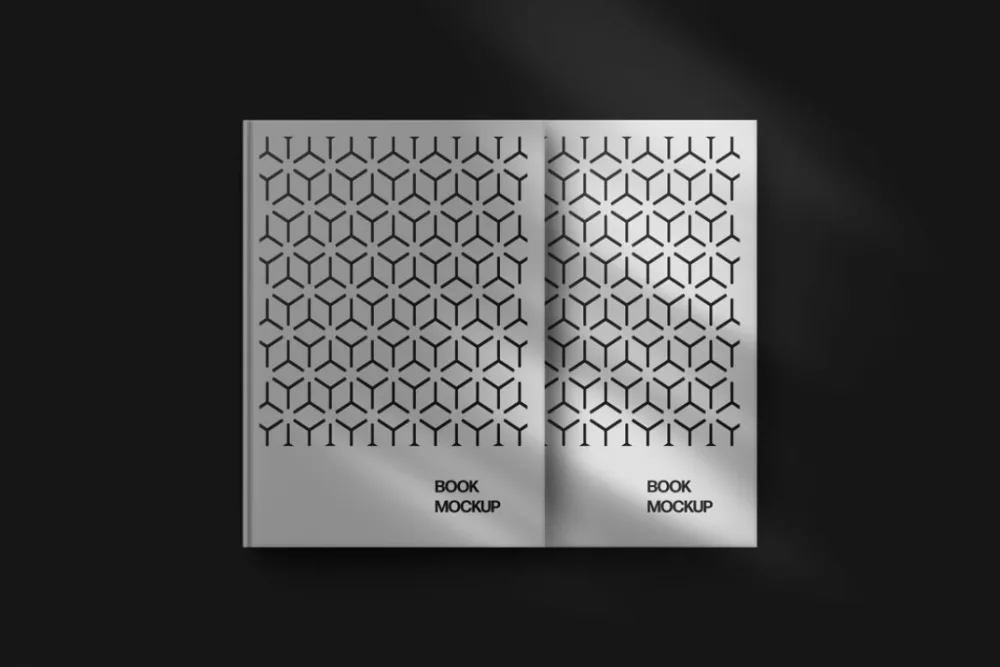 Open book mockup with a geometric patterned design on both pages, set against a dark background. Subtle lighting adds depth, creating soft highlights and shadows for a modern, minimalist presentation.