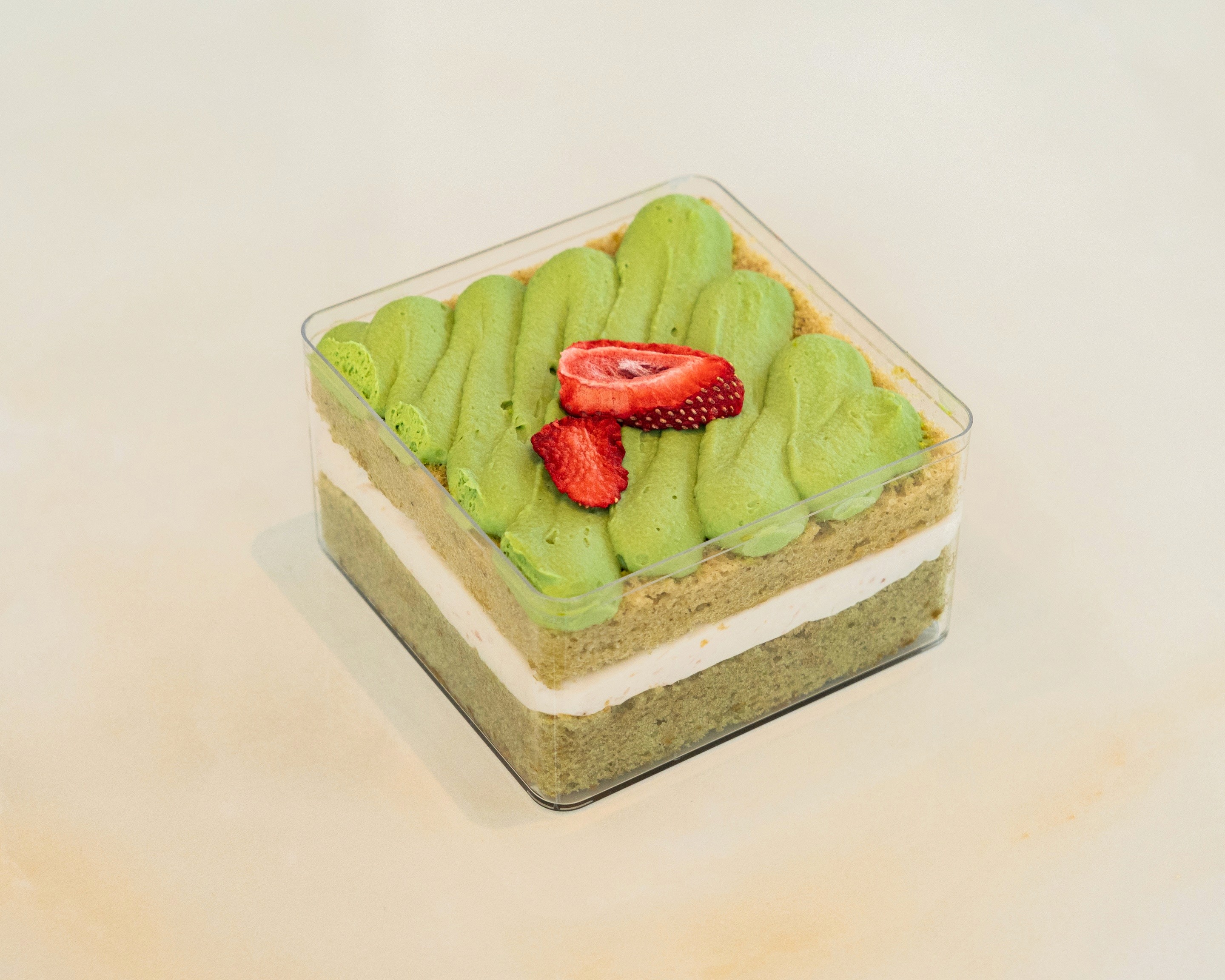 Square matcha layered dessert topped with fresh strawberries at TruLe Yours Cafe Seattle