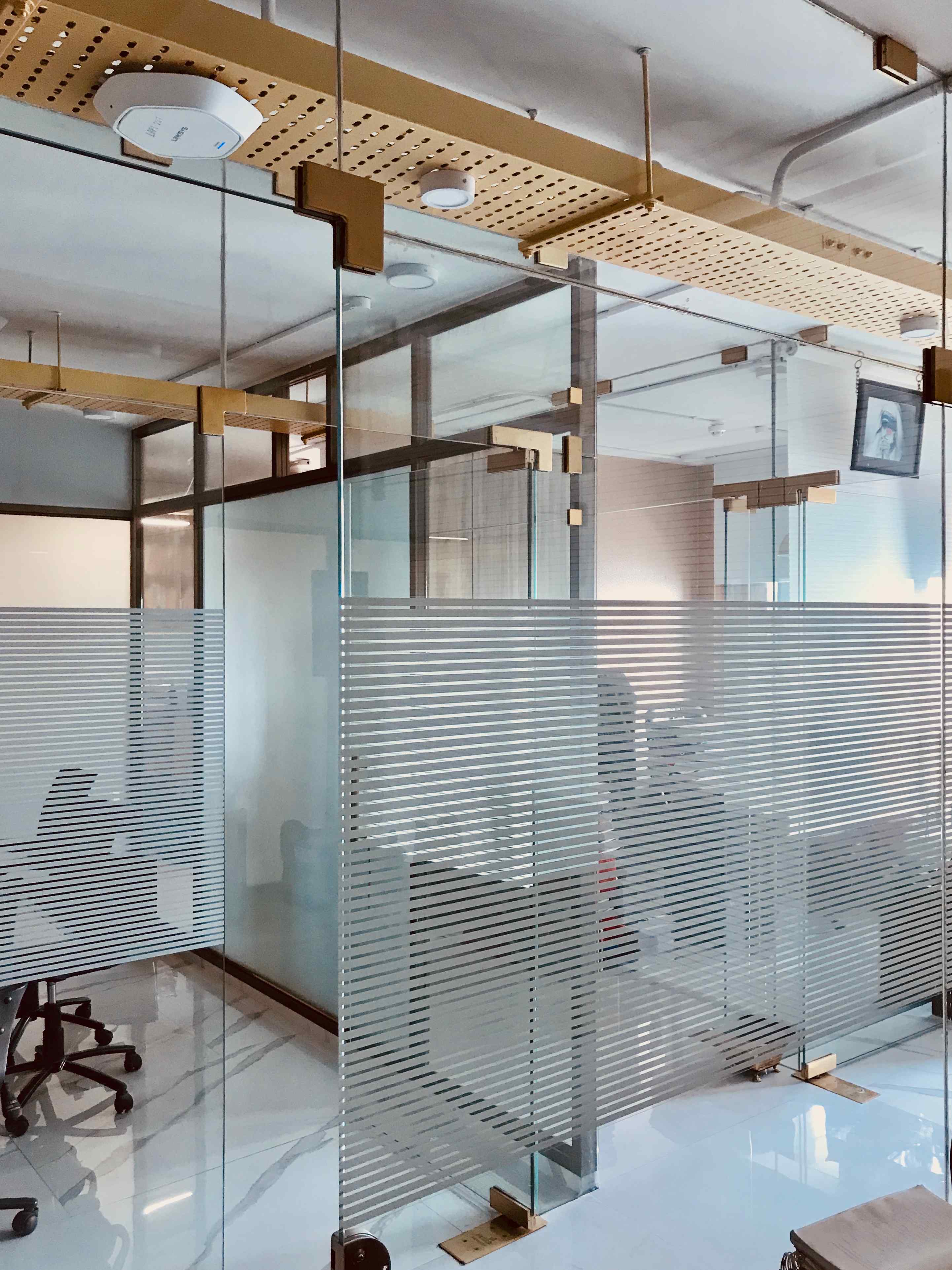 modern law office interior with glass partitions and exposed ceiling services