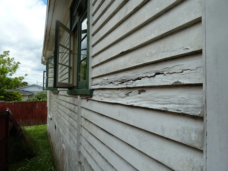 Weathered siding and trim in need of exterior repair