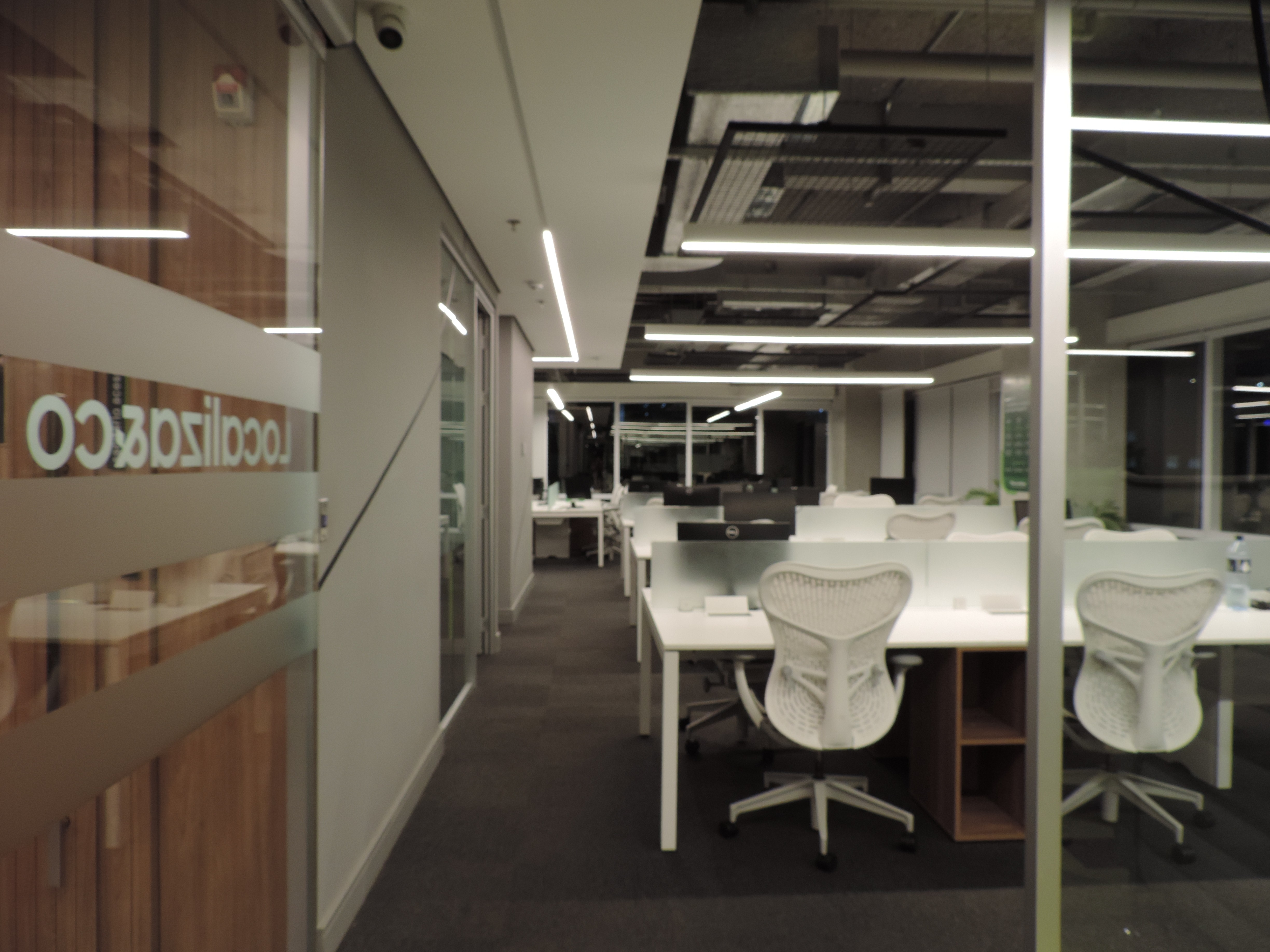 Contemporary interior with sculpted angled walls and a skylight filling the space with natural light.