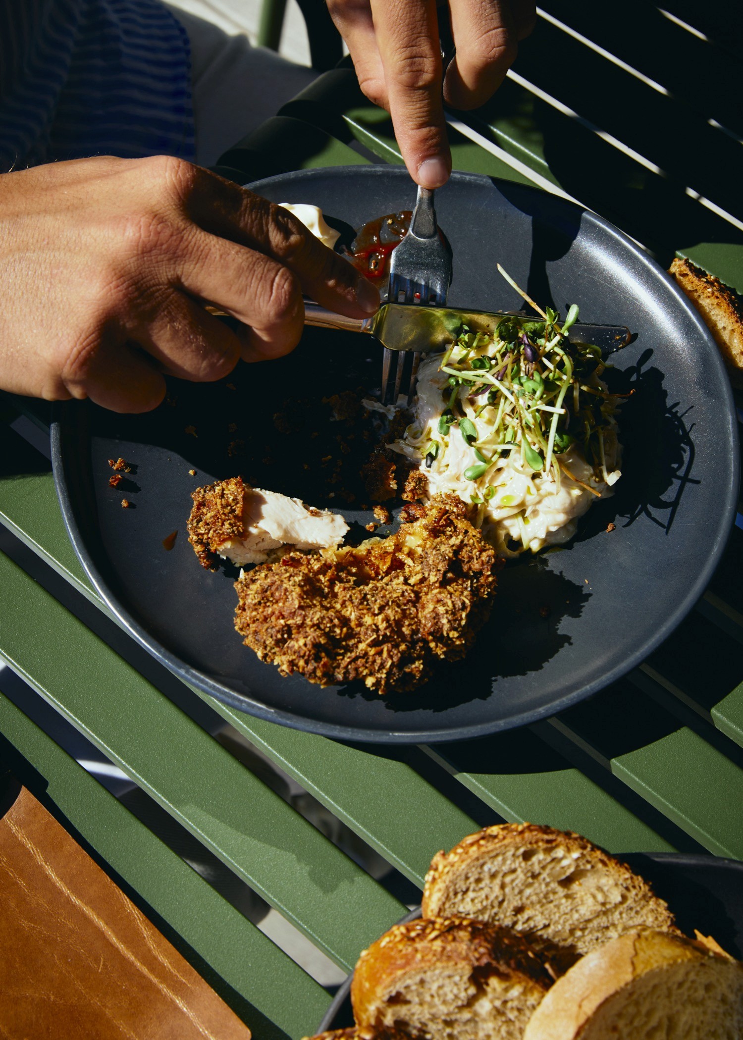 Streetside billboard with flyposters of the Batch.Works brand and illustrations