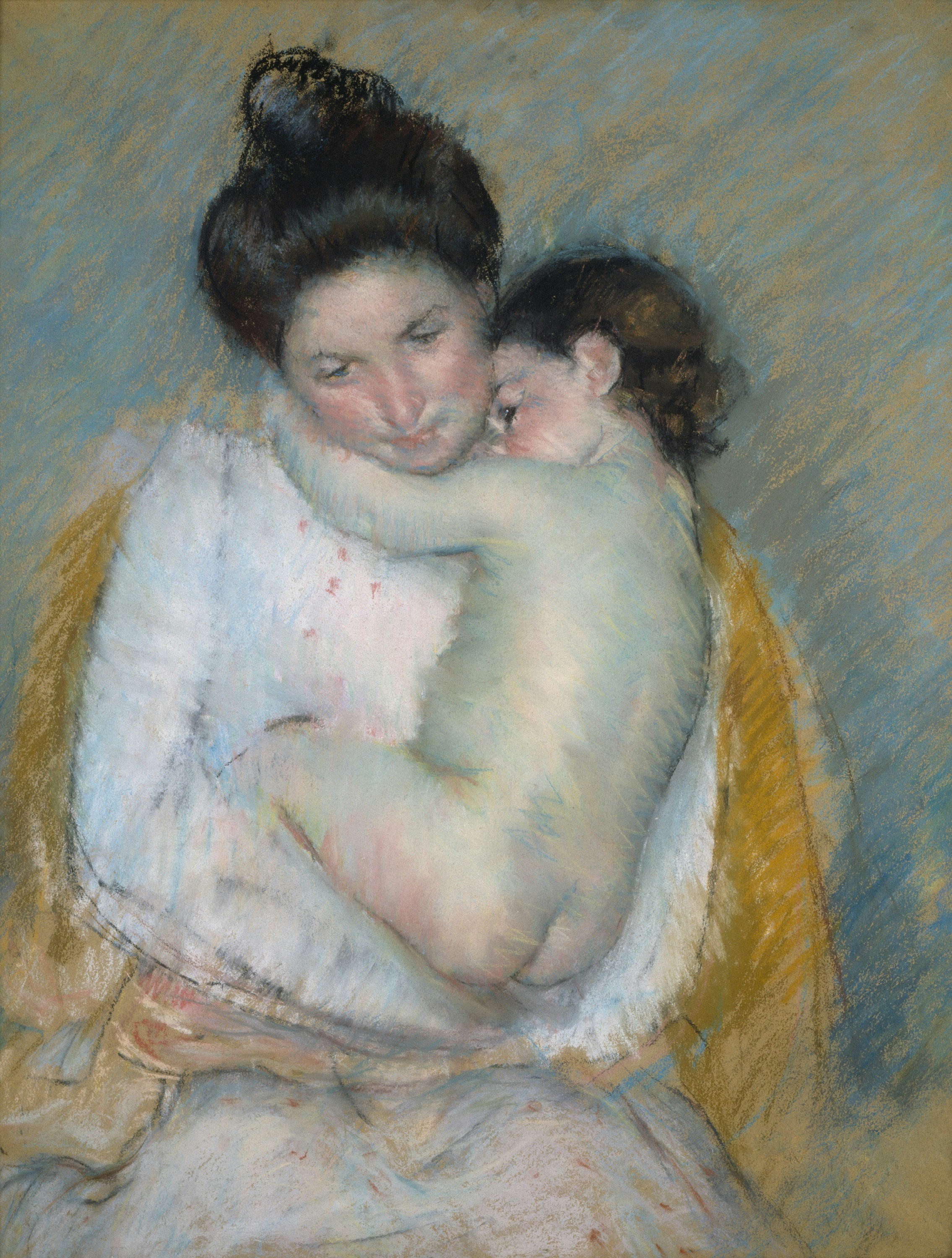 Mother holding a sleeping baby close to her chest.