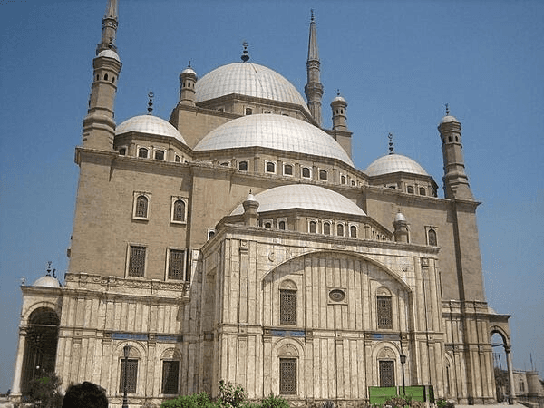 A tall Egyptian Mosque with domes and minarets