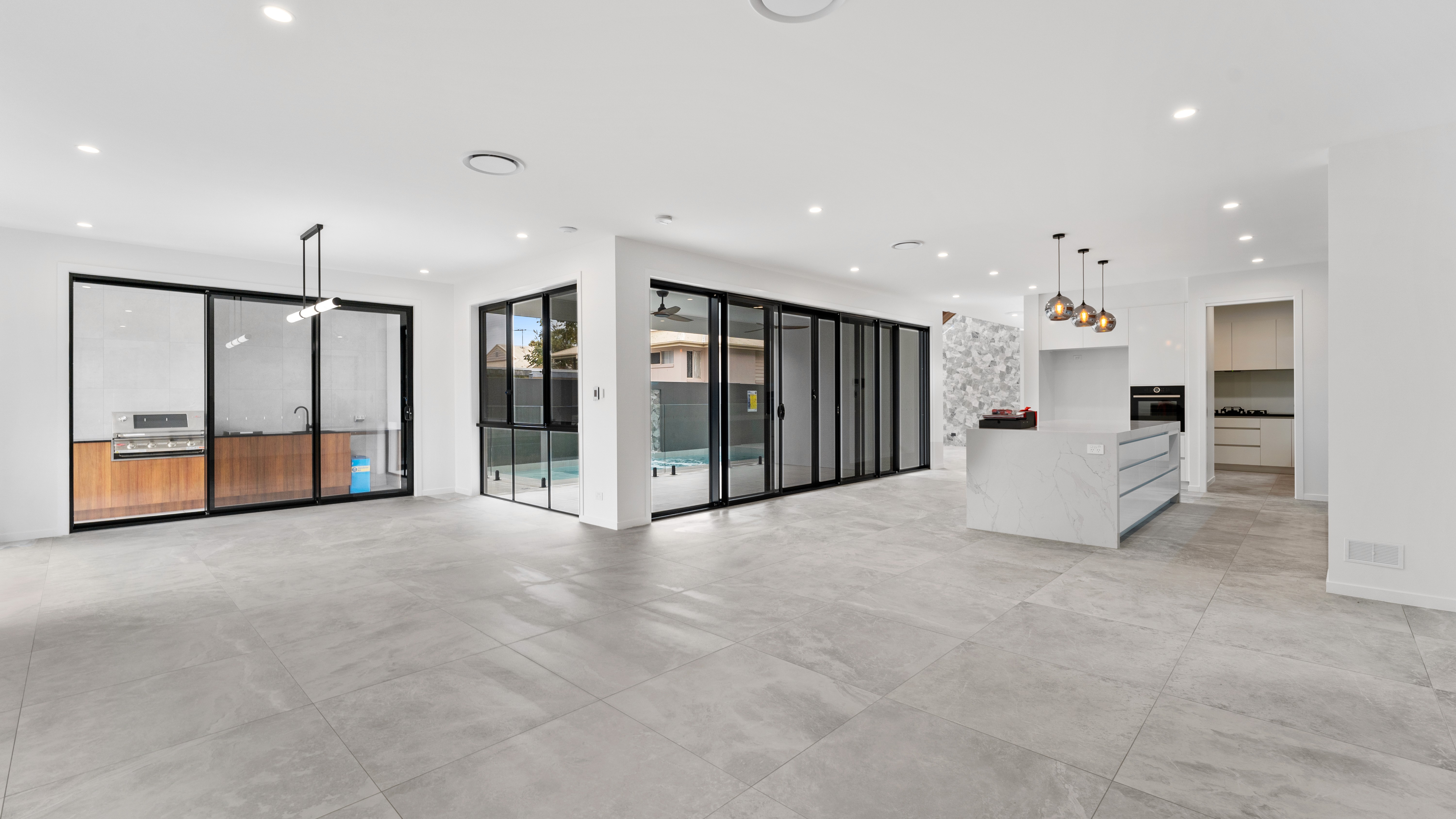 Modern custom home design in Brisbane featuring open-plan living and seamless indoor-outdoor flow by Flascon Construction