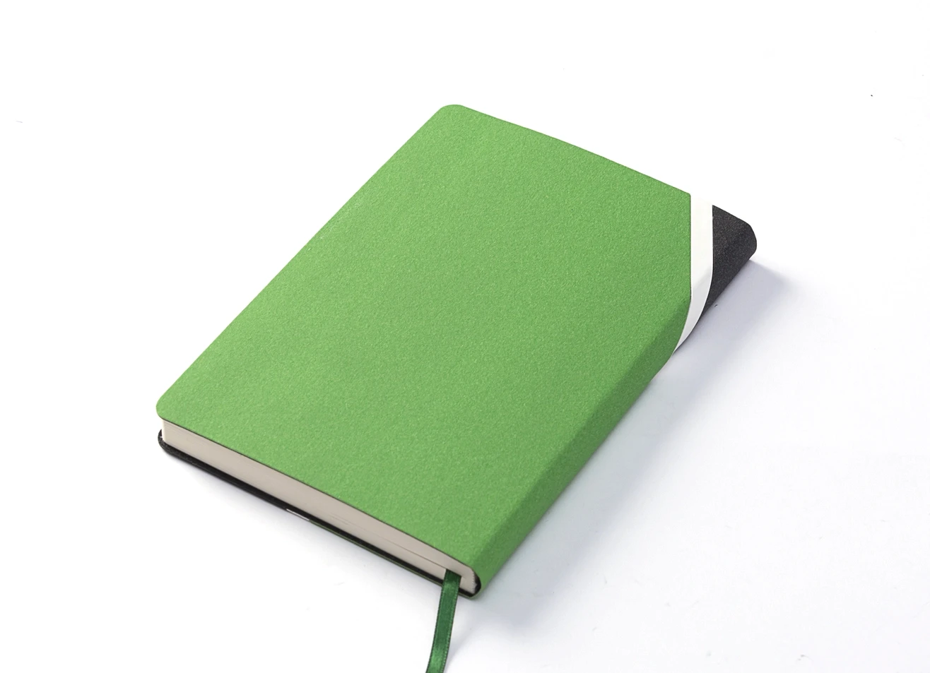 Back angled view of green and black notebook.